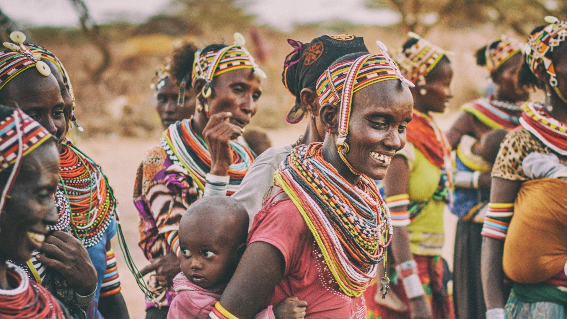 group of people standing on brown ground