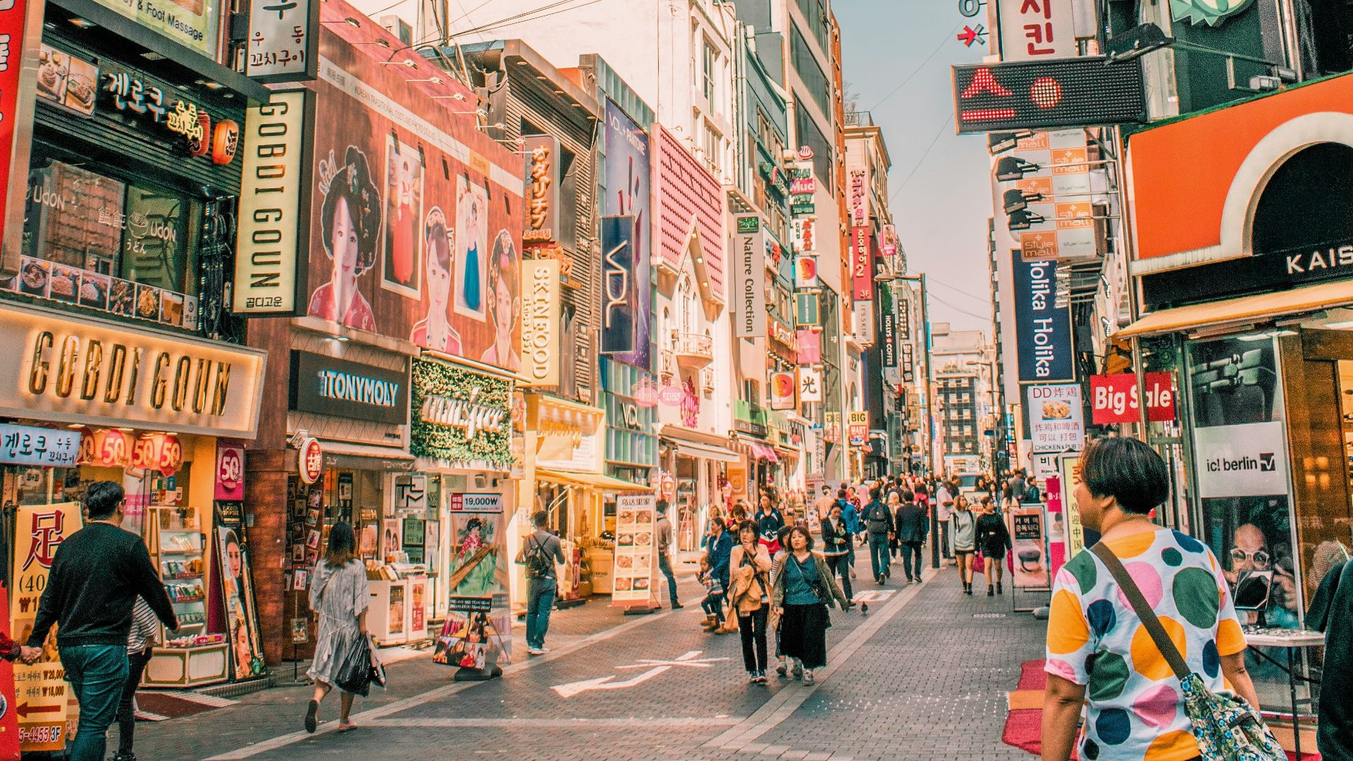 people walking on road surrounded by buildings