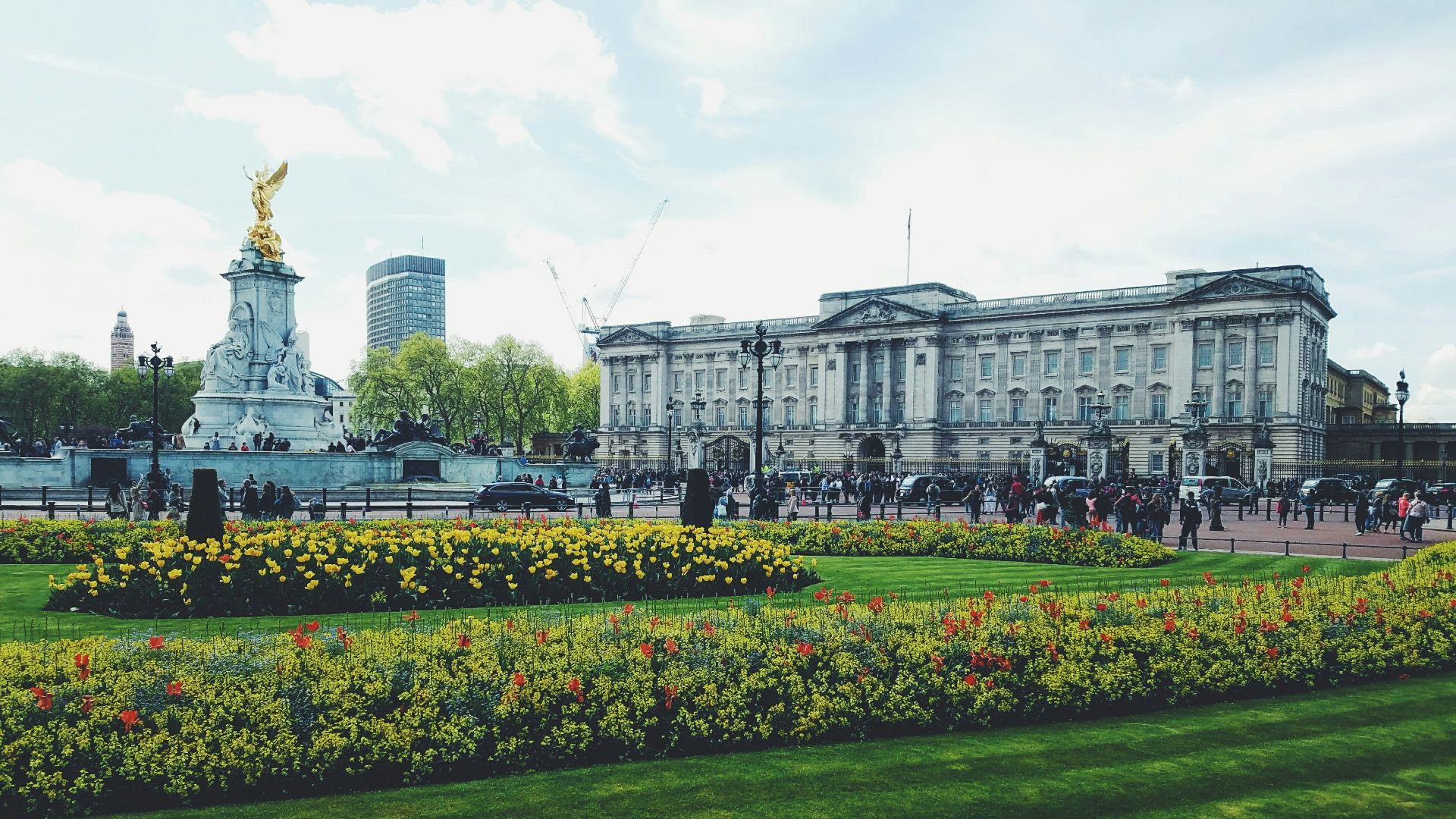 white concrete building near green grass field under white sky during daytime