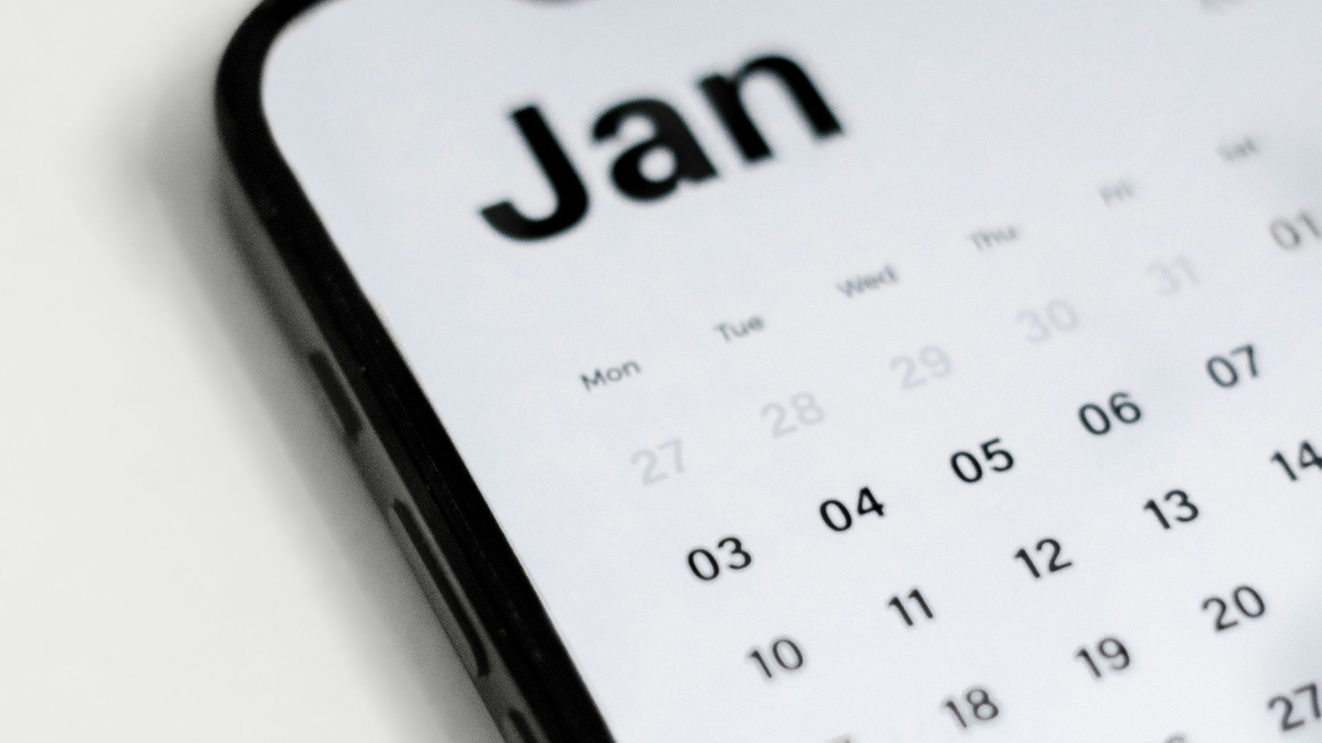 a close up of a cell phone with a calendar on it