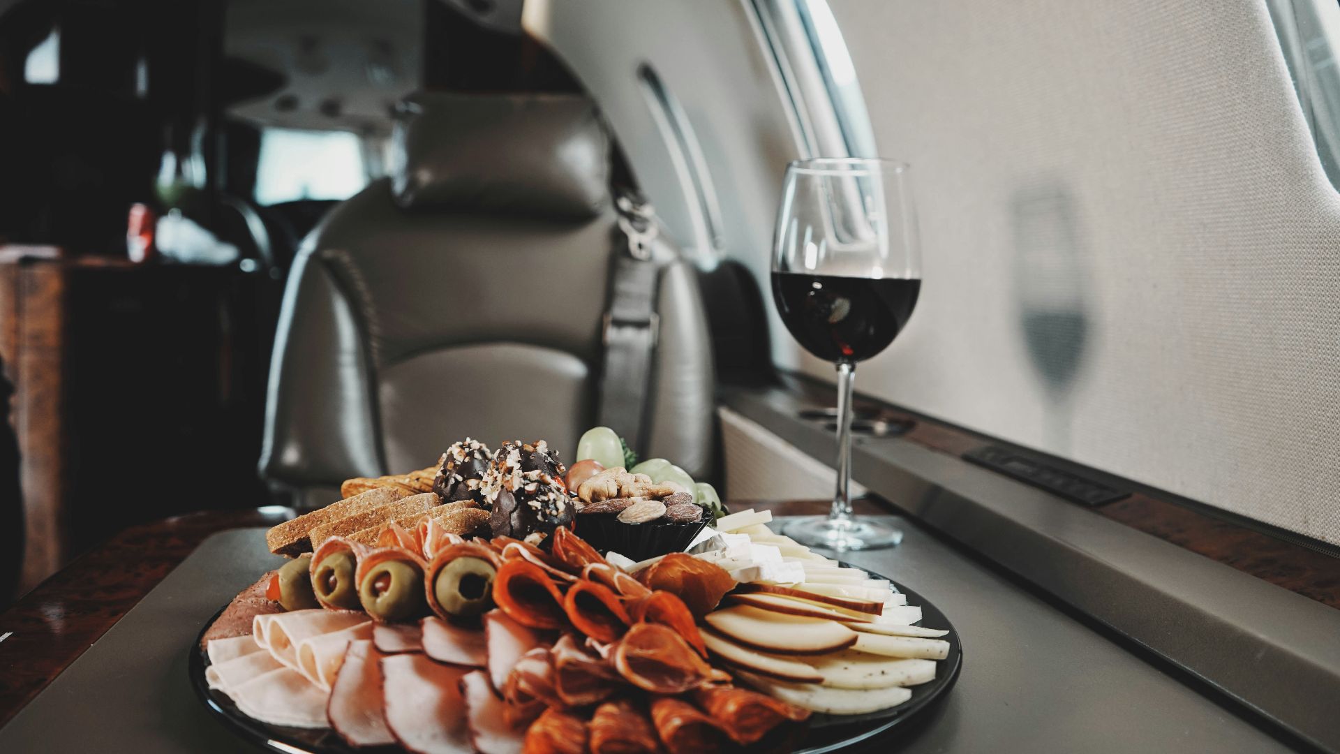 a plate of food and a glass of wine on a table