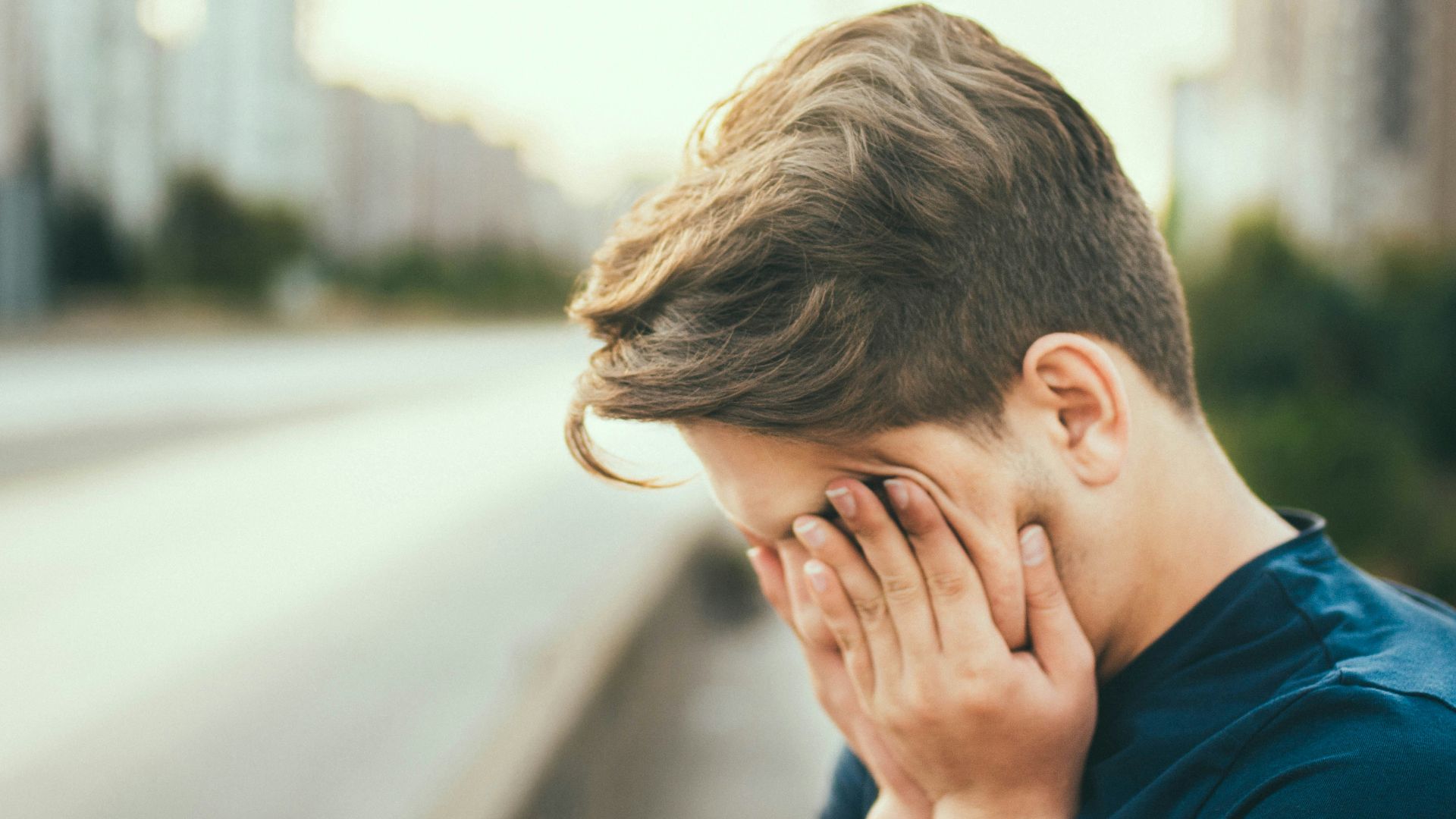 person covering own face