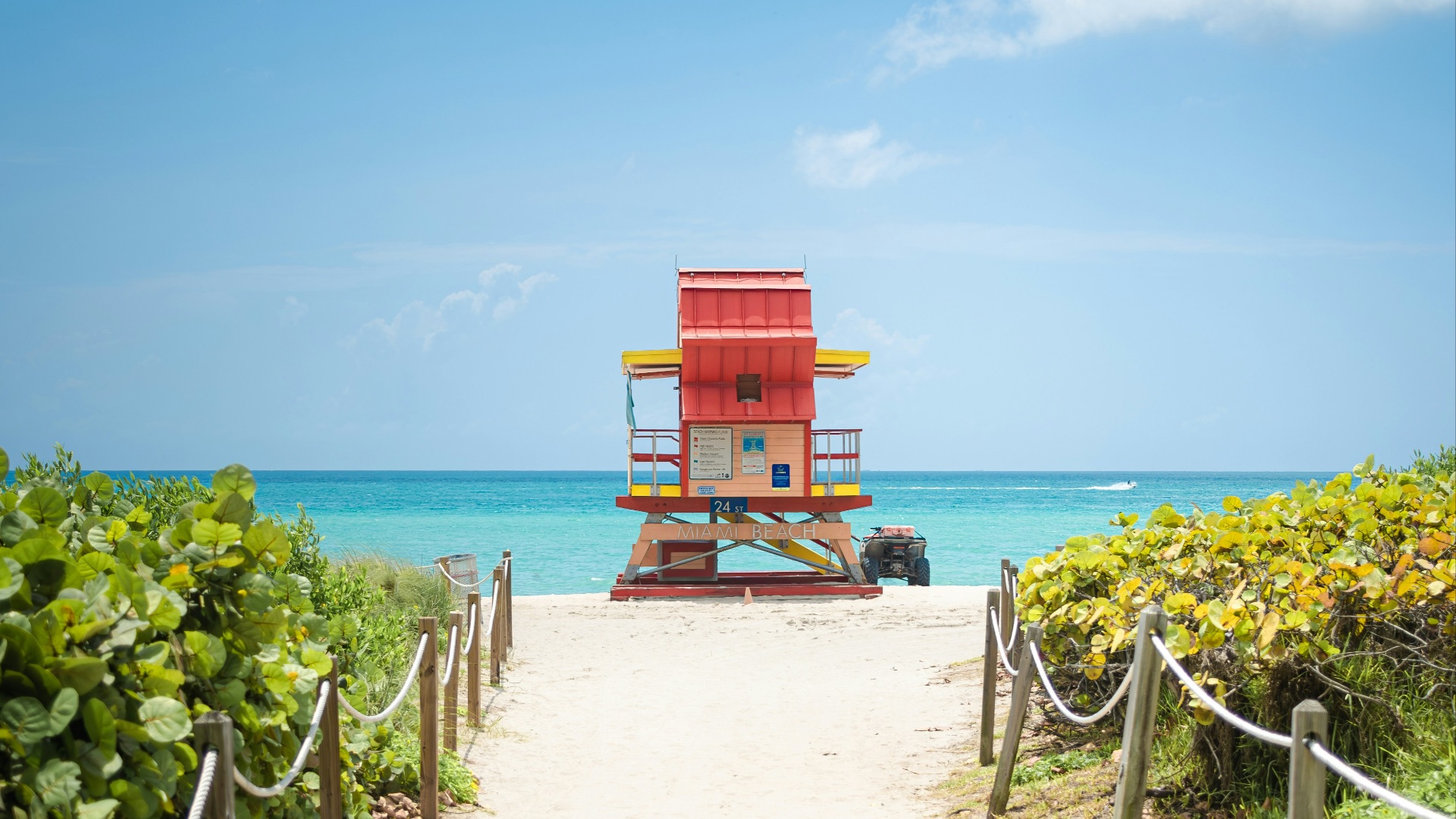 a red lifeguard tower sitting on top of a sandy beach