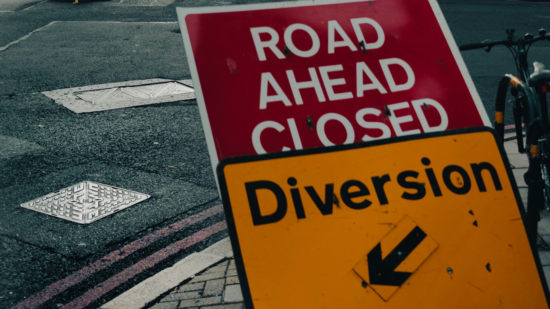 a road ahead closed sign on the side of the road