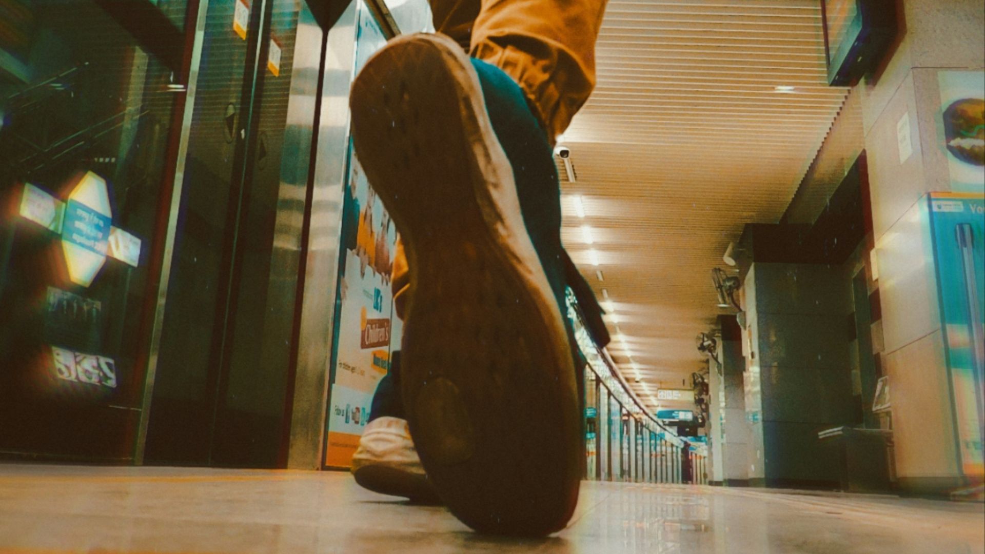 a person walking down an escalator in a building