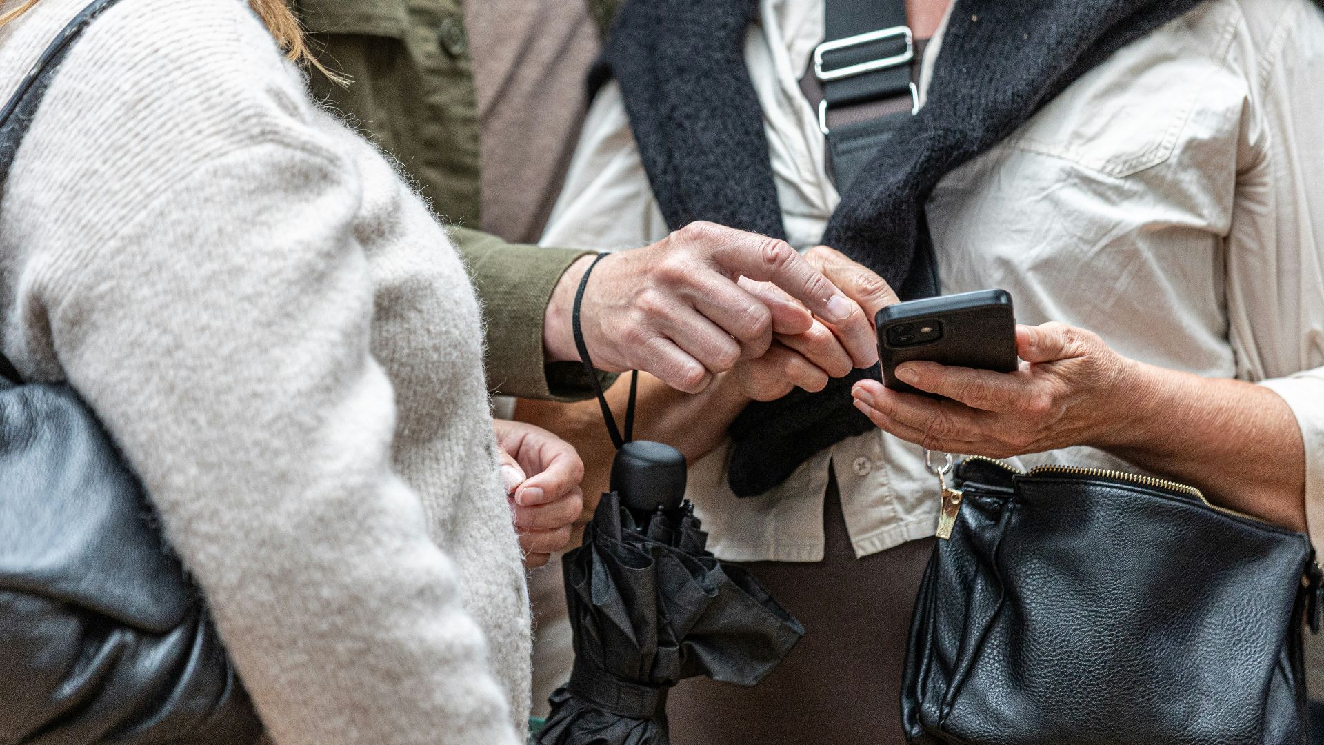 Two people looking at a smartphone screen together
