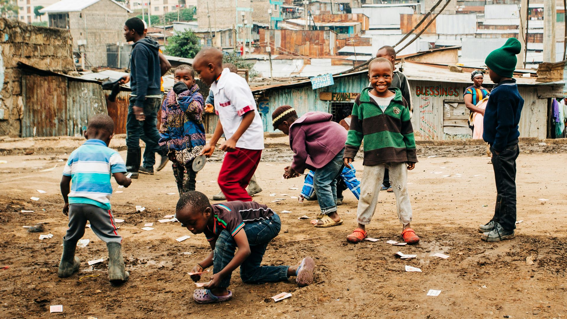 children playing on brown sand at daytime