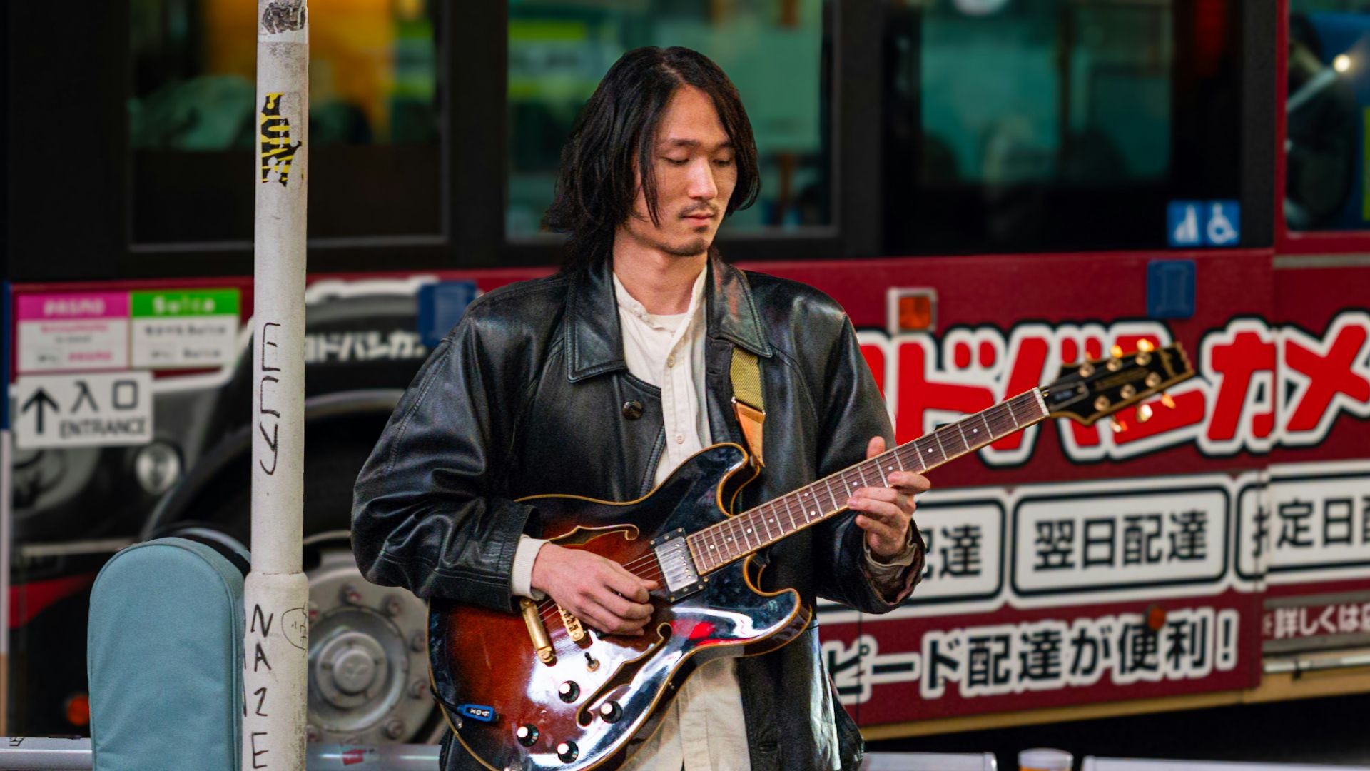 Man playing guitar on a city street