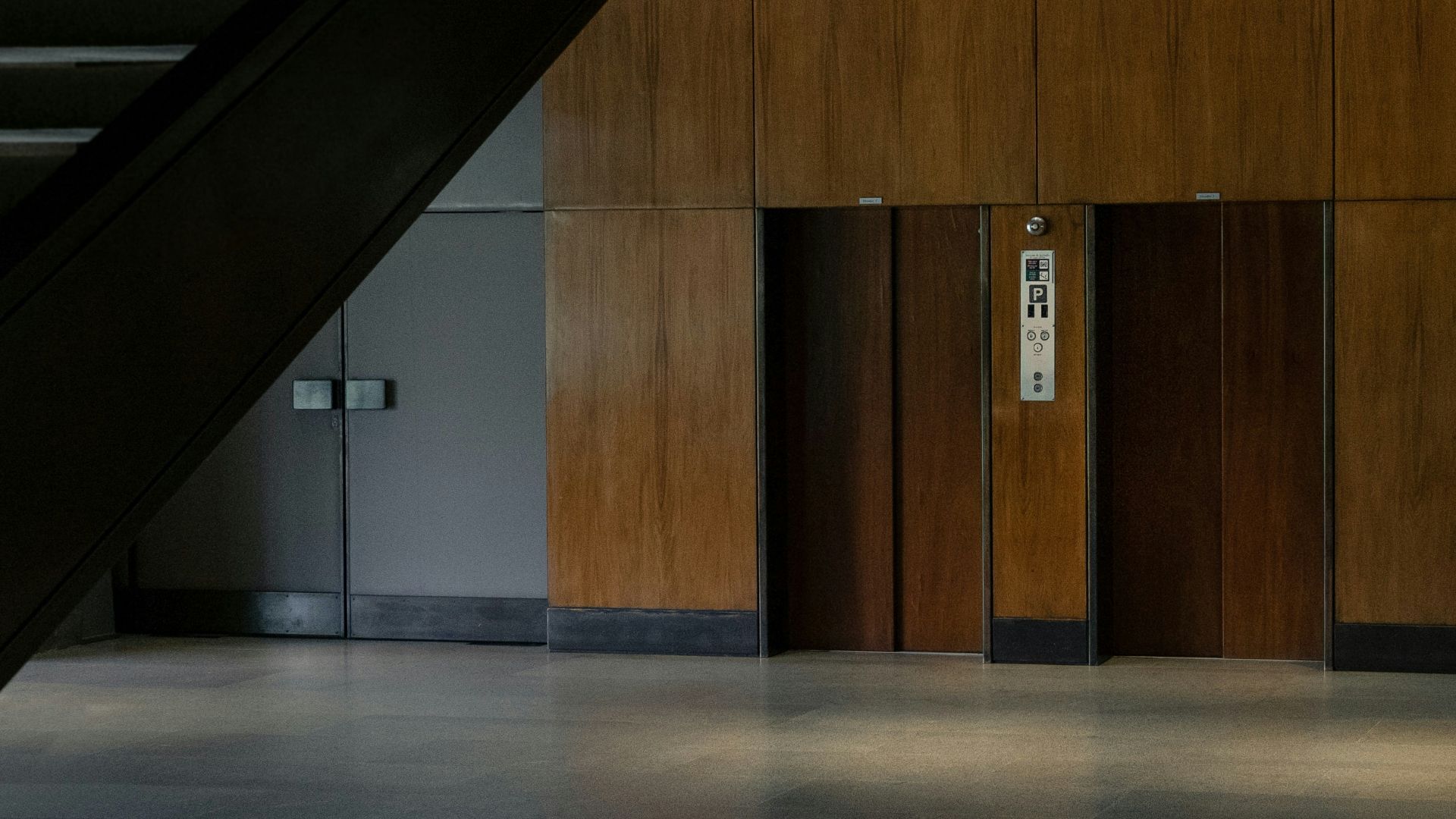 brown wooden door on white wall