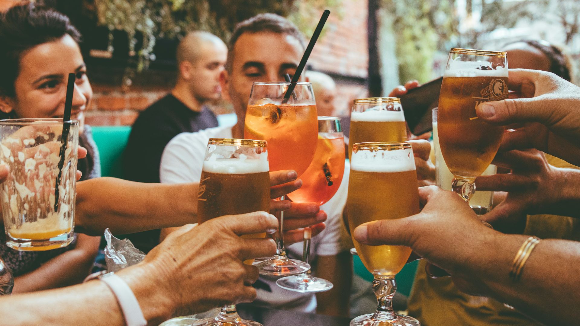 people holding drinks during day
