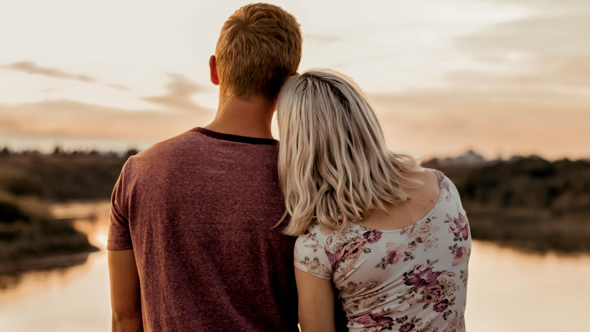 man and woman standing on brown field during daytime
