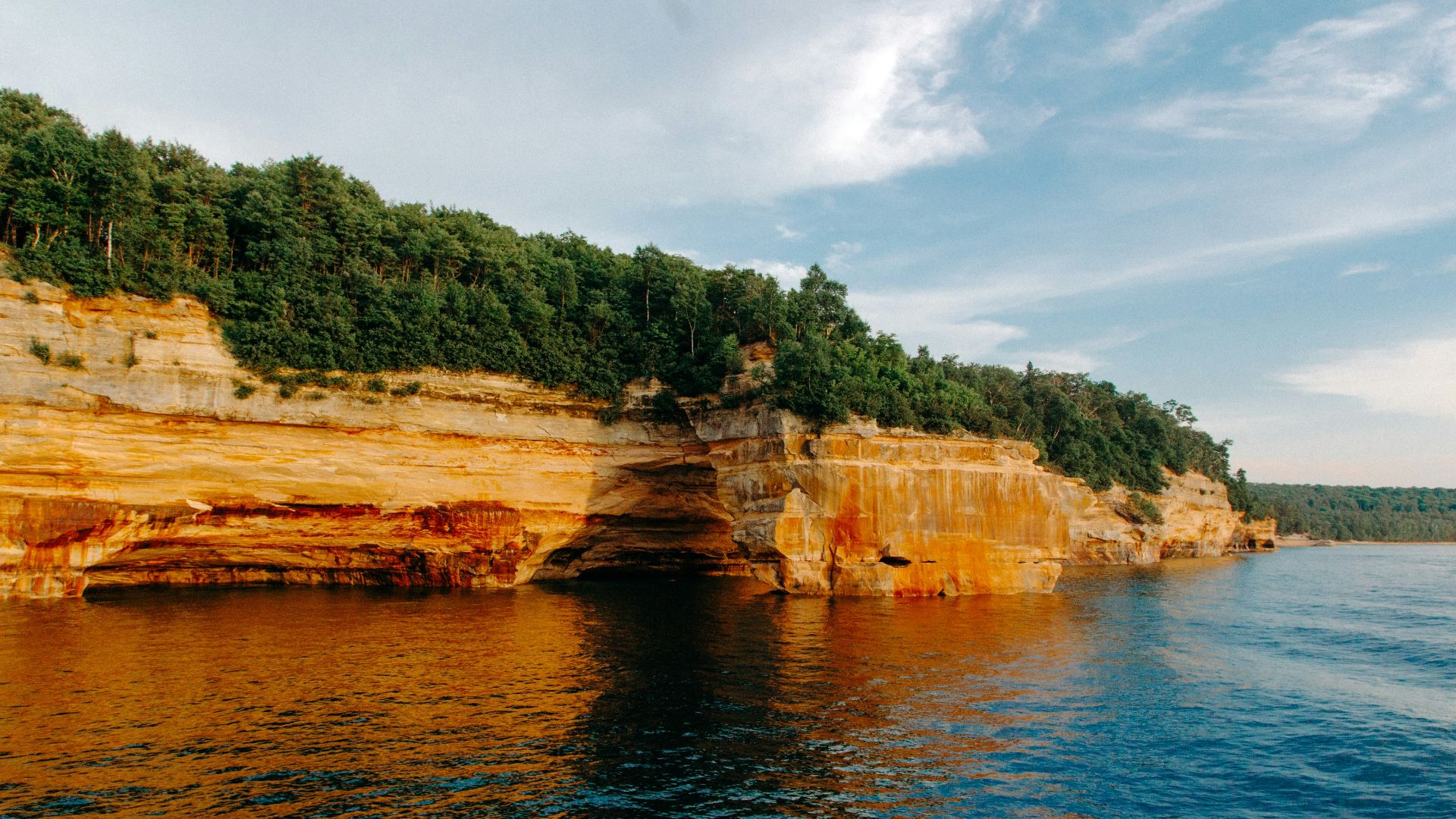mountain near body of water at daytime