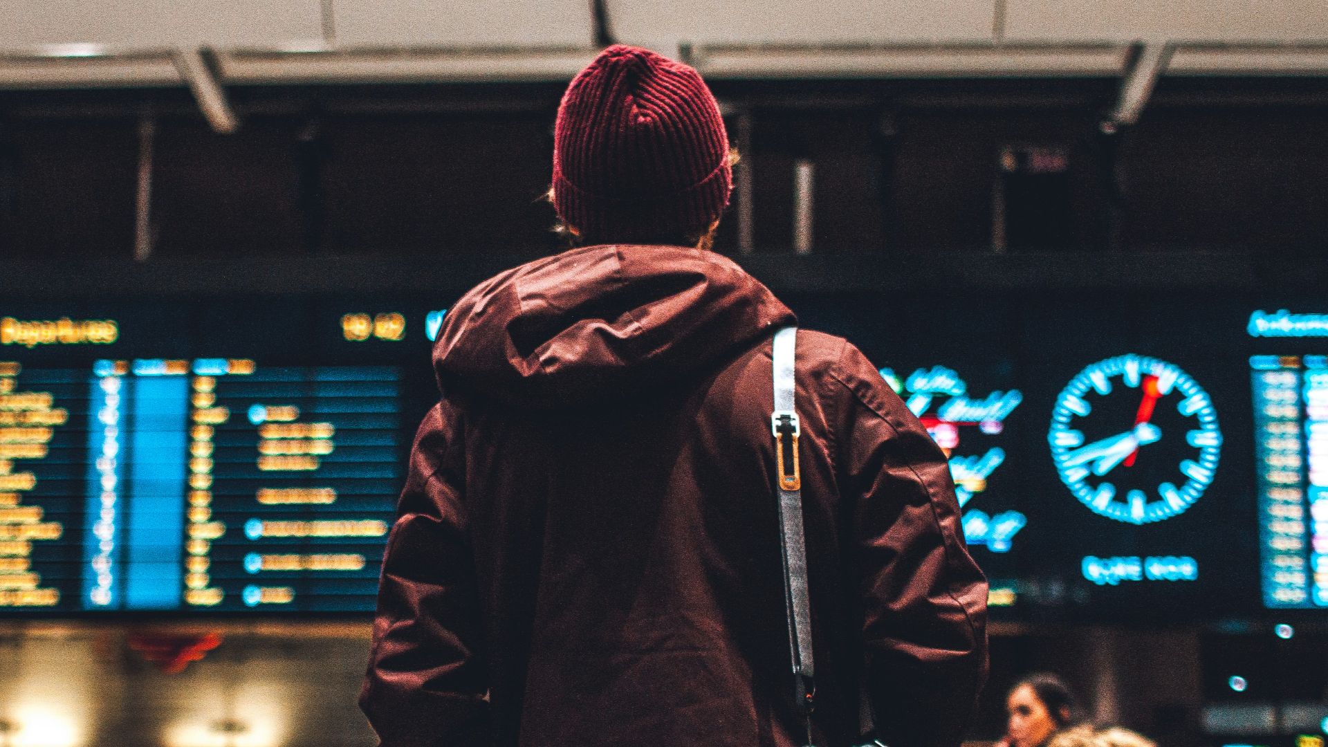 person looking up to the flight schedules