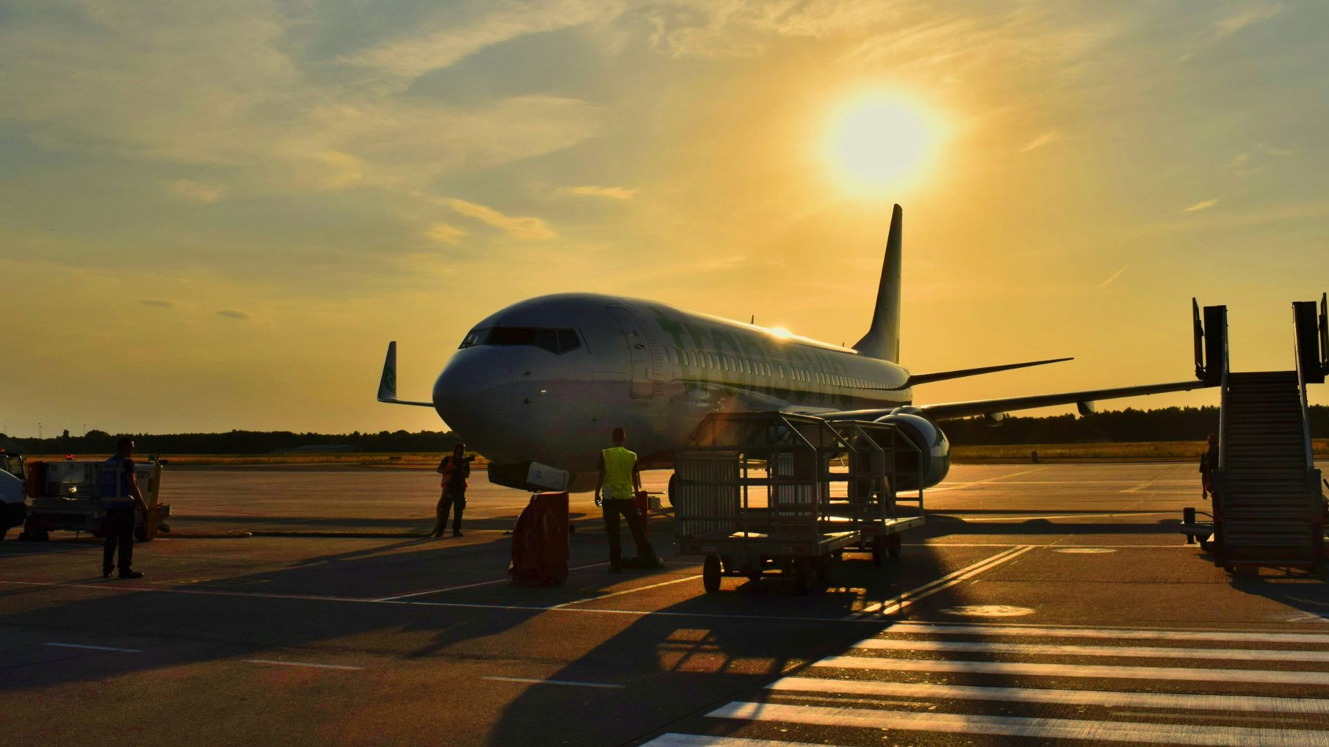 white airplane parked during daytime