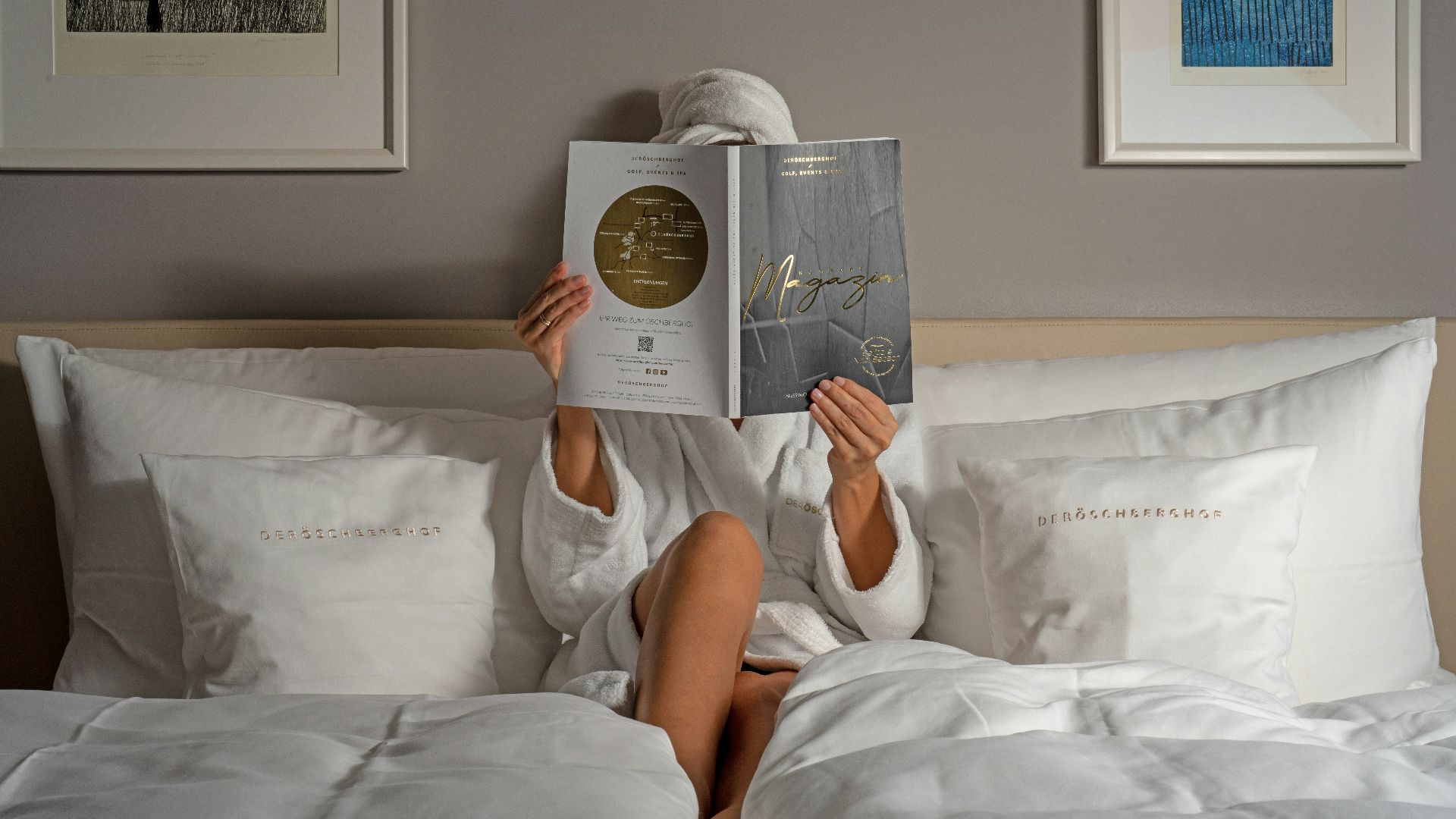 a person reading a book on a bed
