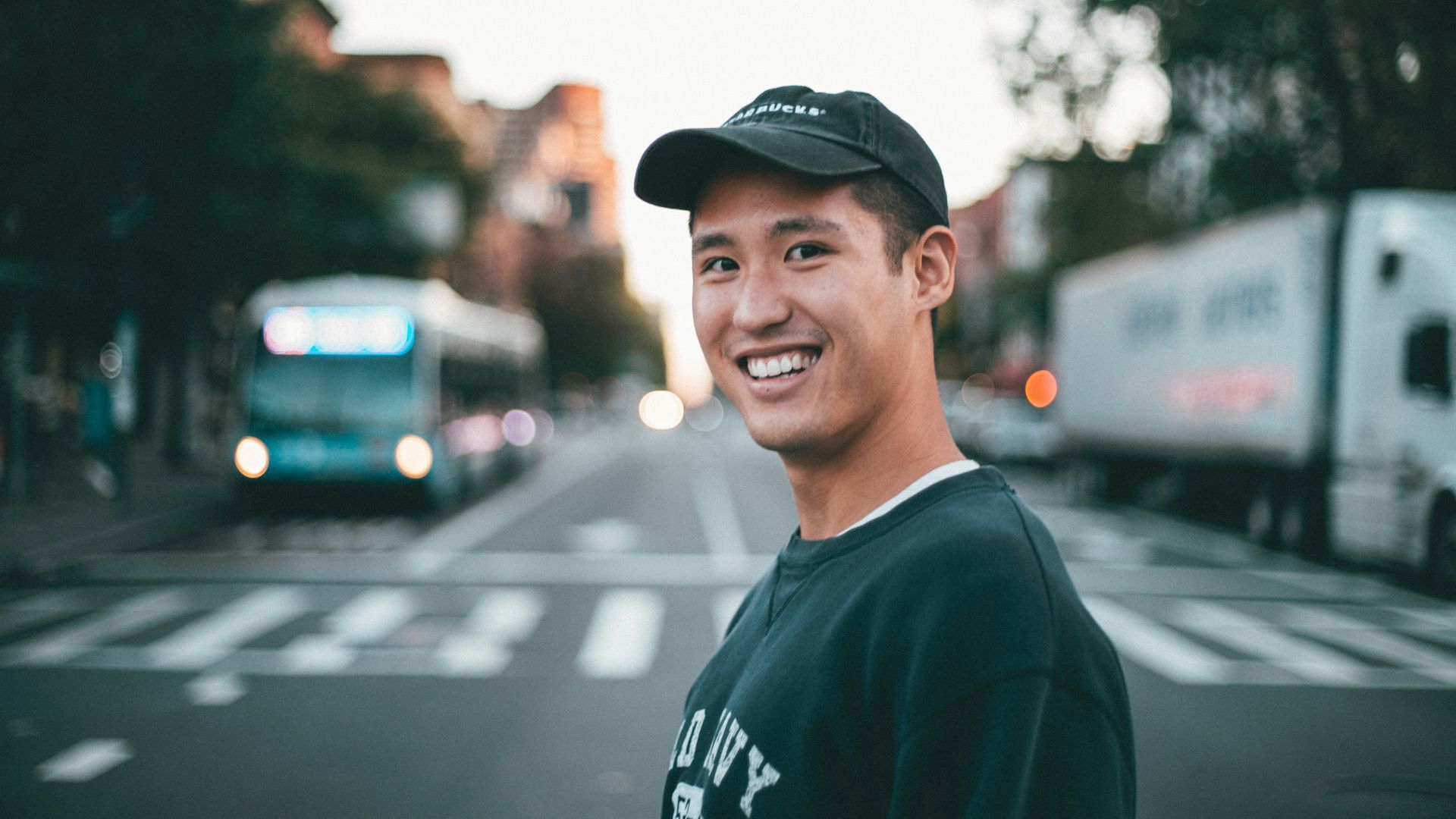 man stranding on straight road photo during daytime