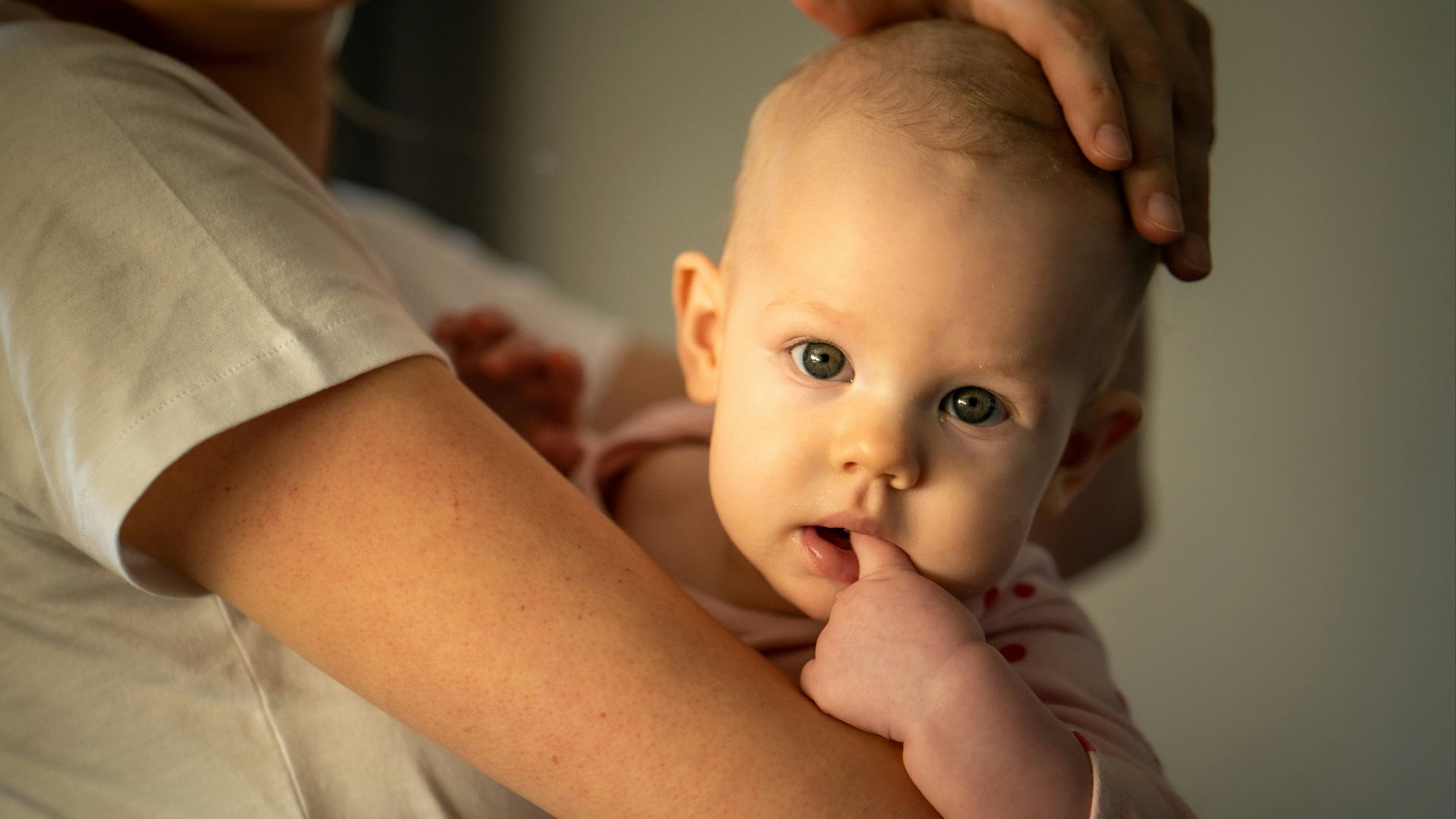 a woman holding a baby in her arms