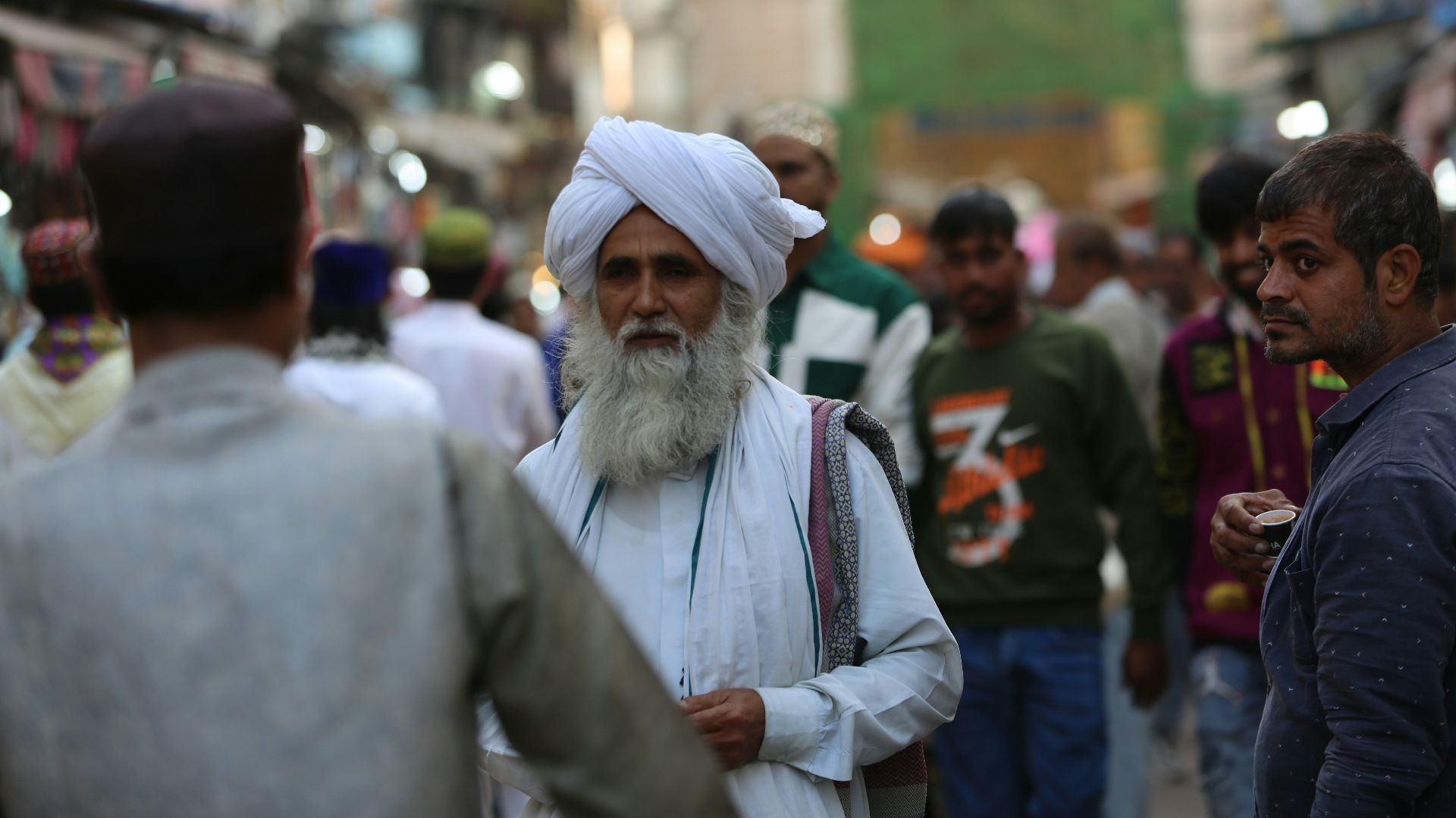 Elderly man with white turban and beard in crowd