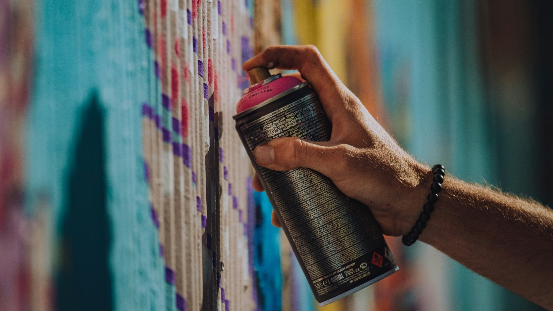 person holding black and red can