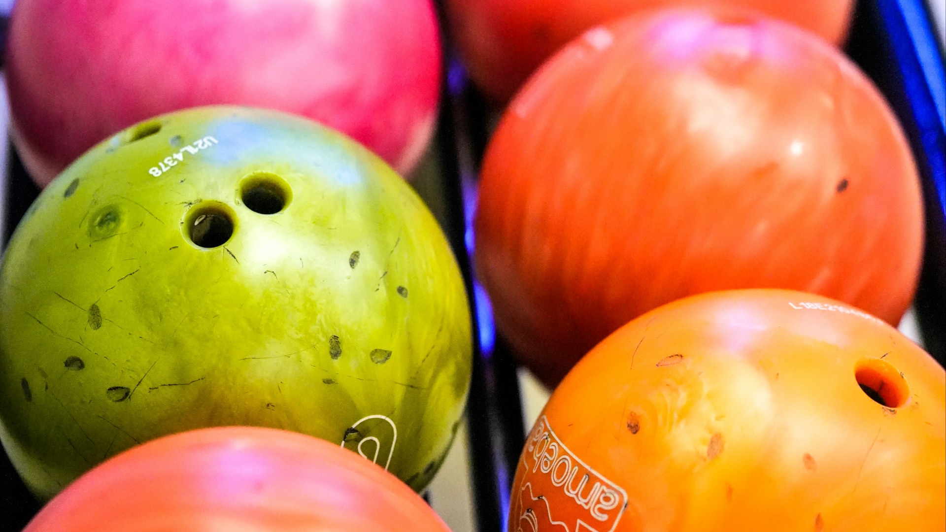 A rack of colorful bowling balls
