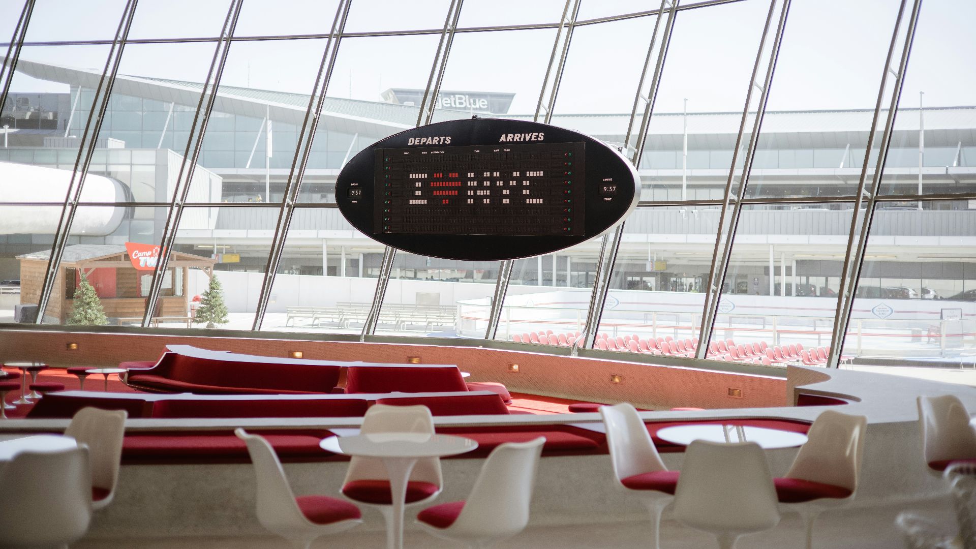 a clock hanging from the ceiling of a building