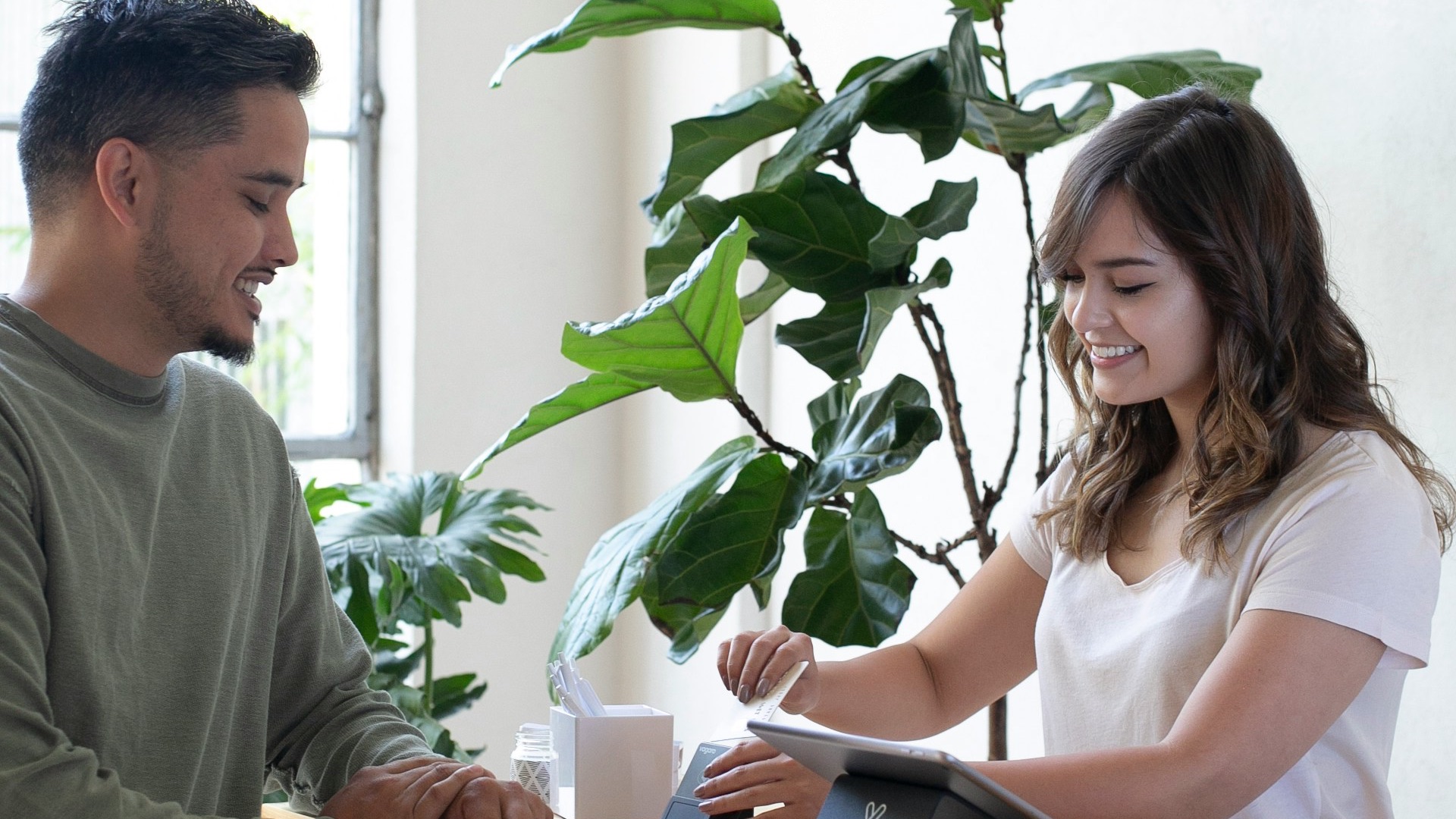 a man and a woman shaking hands over a desk