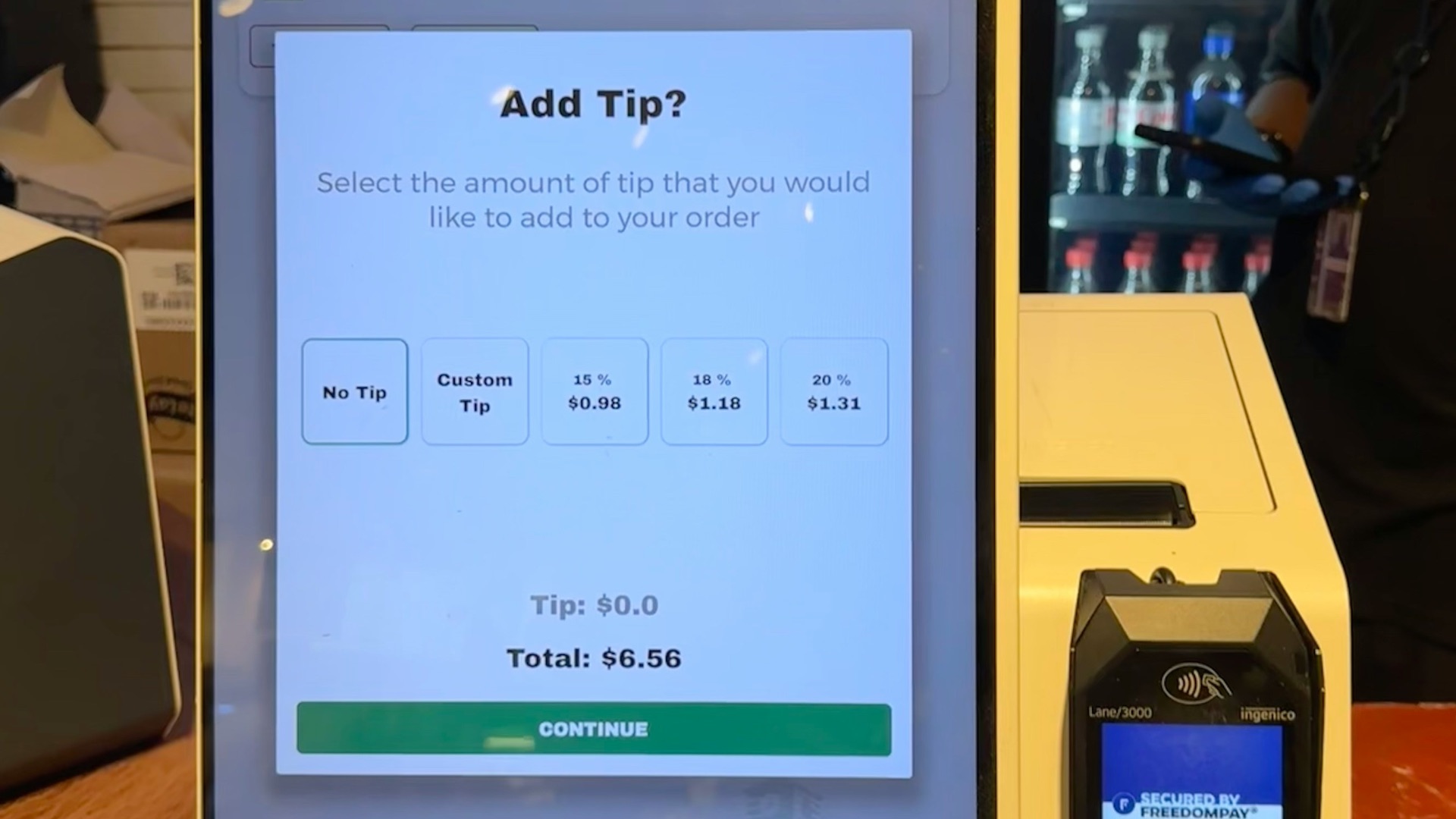 A checkout counter with a cell phone on it