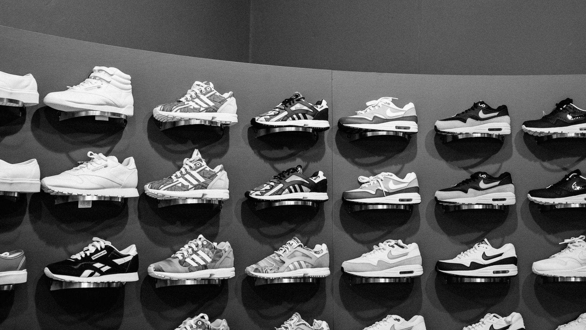 a large display of shoes in a black and white photo