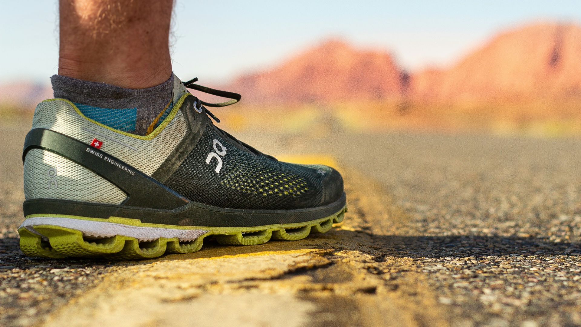 person wearing black and yellow nike running shoes