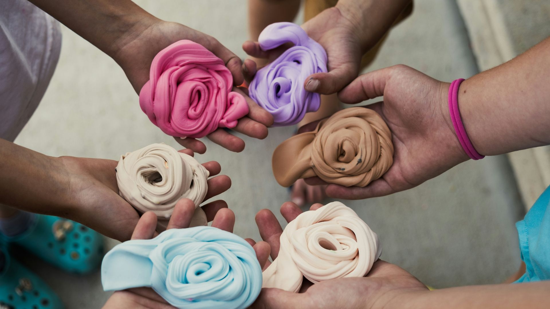 a group of people holding different colored flowers