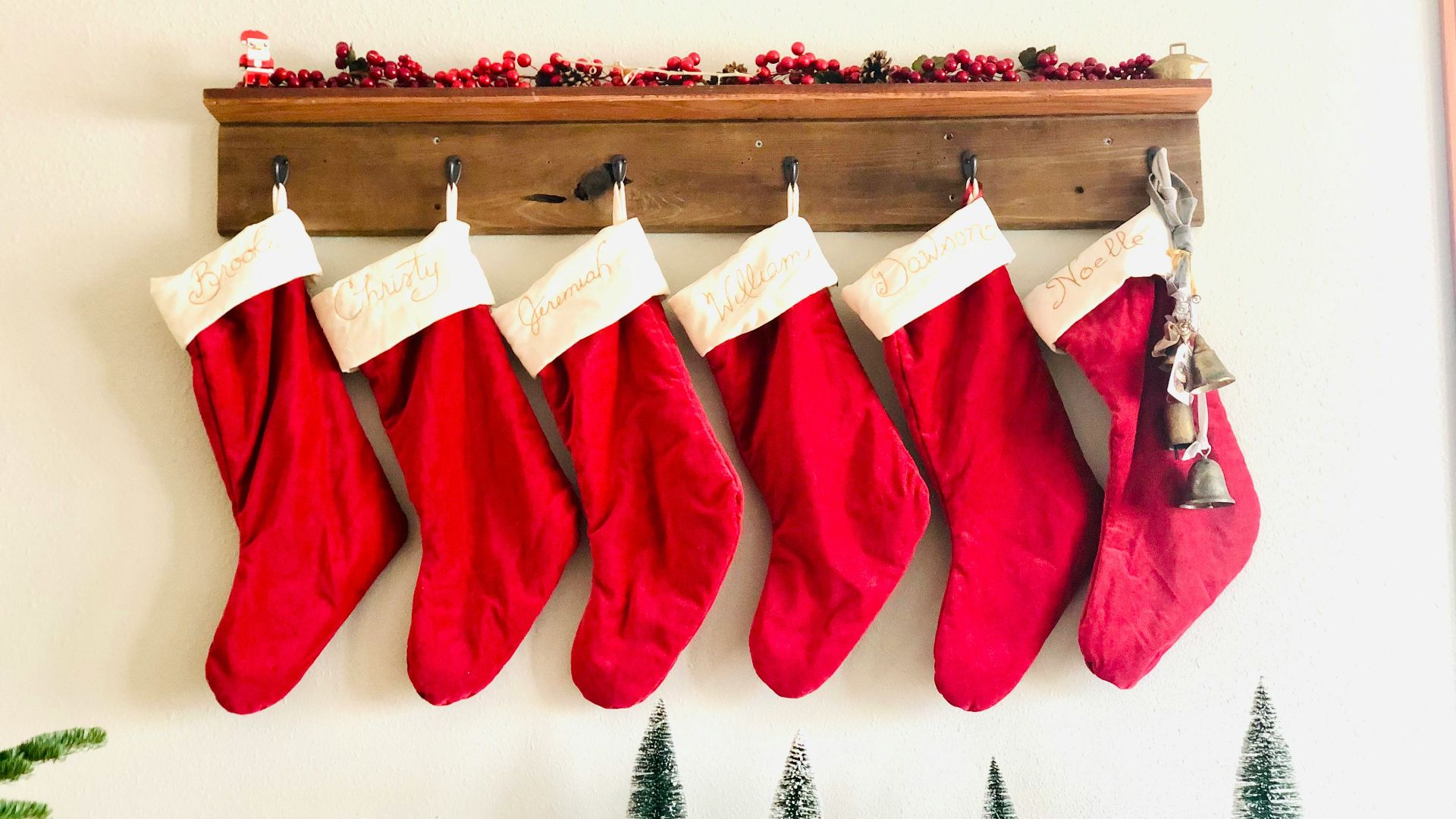a group of red and white stockings from a wooden shelf
