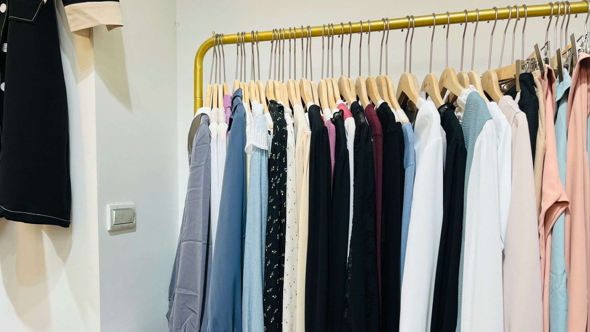 a rack of clothes hanging on a clothes rack