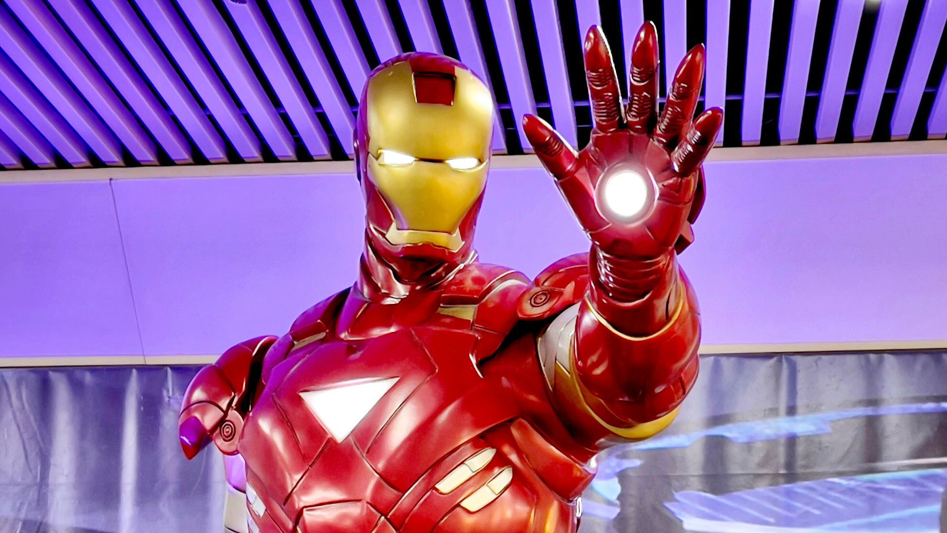 a statue of iron man is displayed in a museum