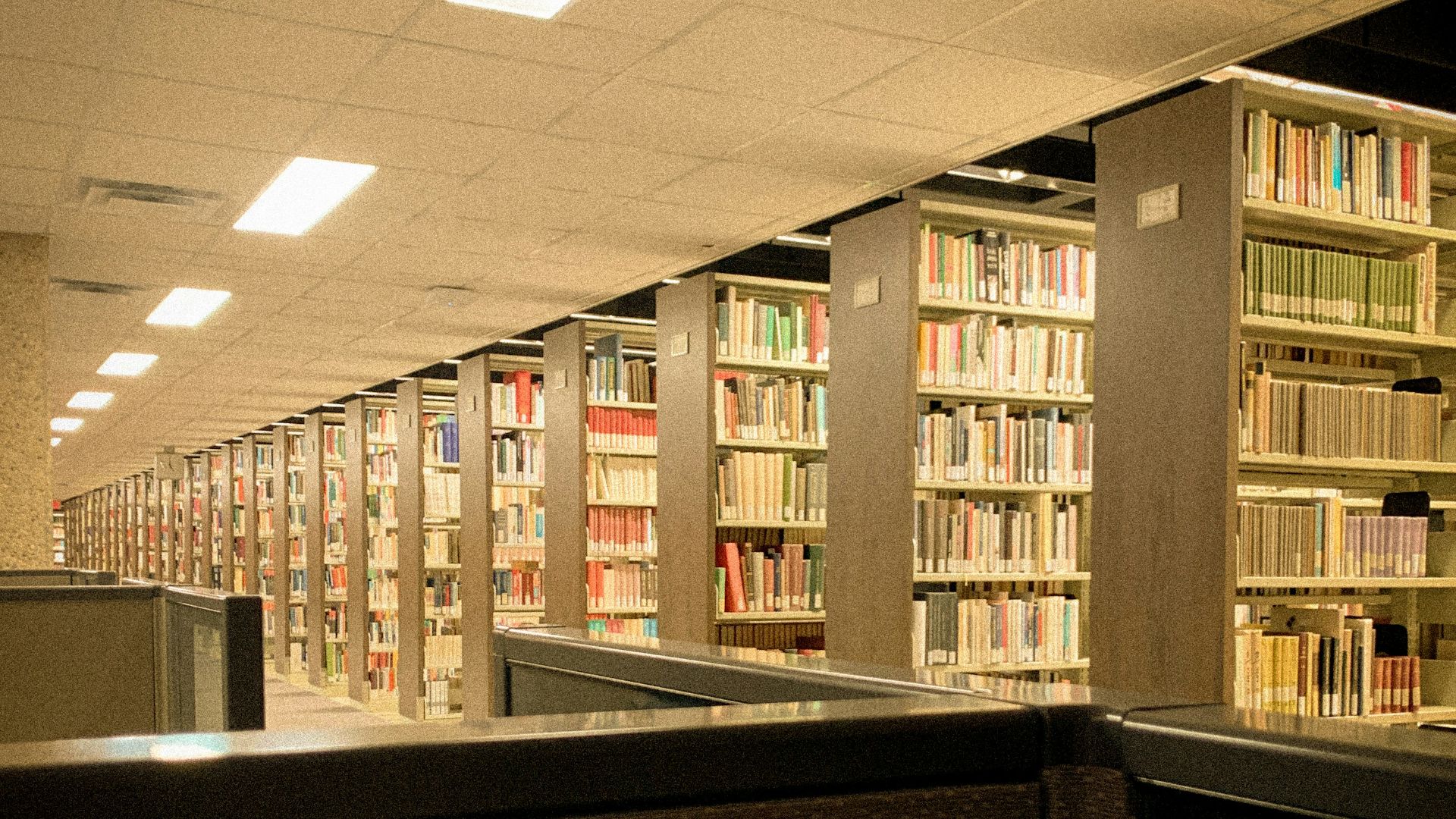 a row of bookshelves in a library filled with lots of books