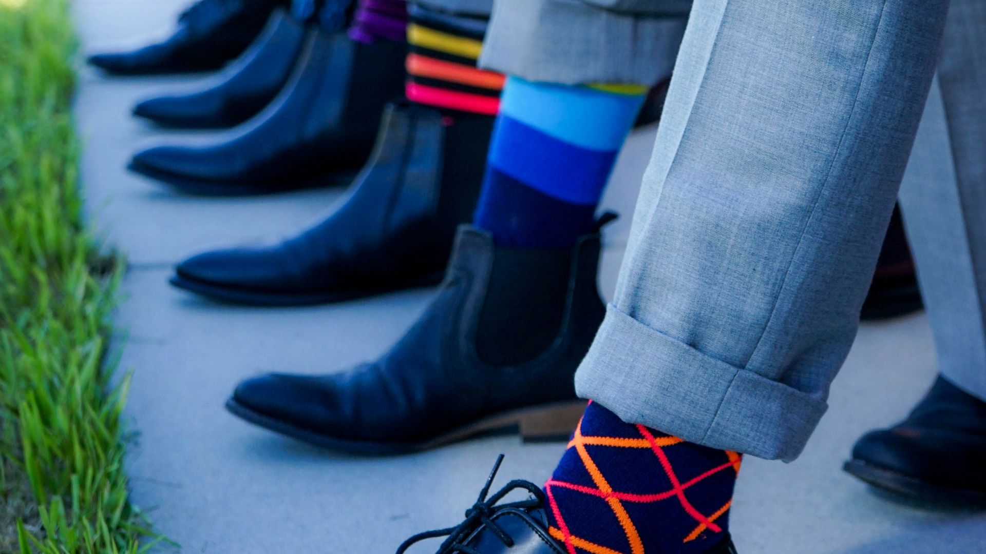 people showing black leather dress shoe lot outdoor during daytime