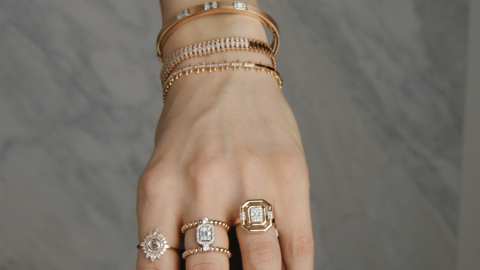 A woman's hand with rings and a purse