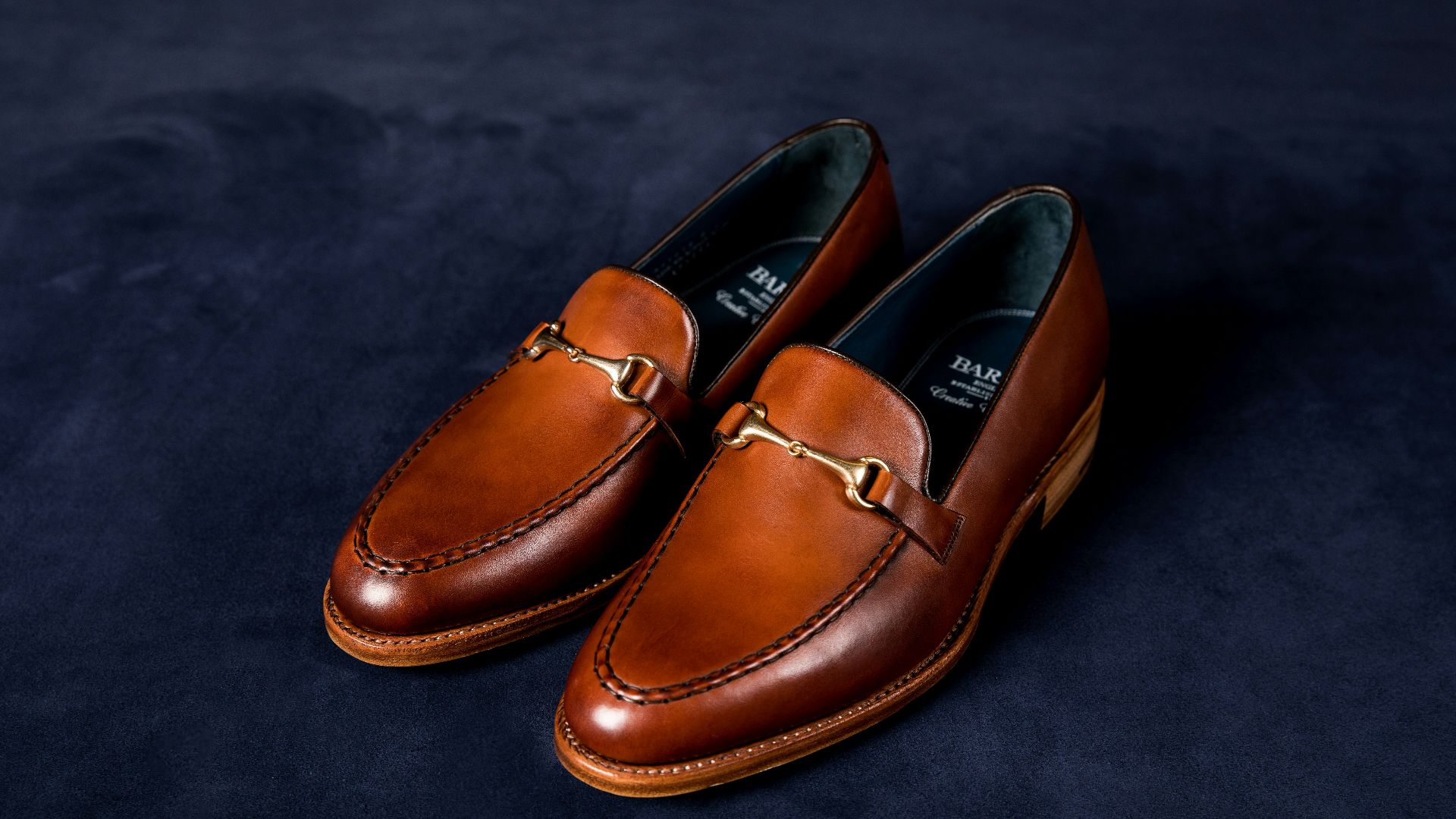 brown leather loafers on blue textile