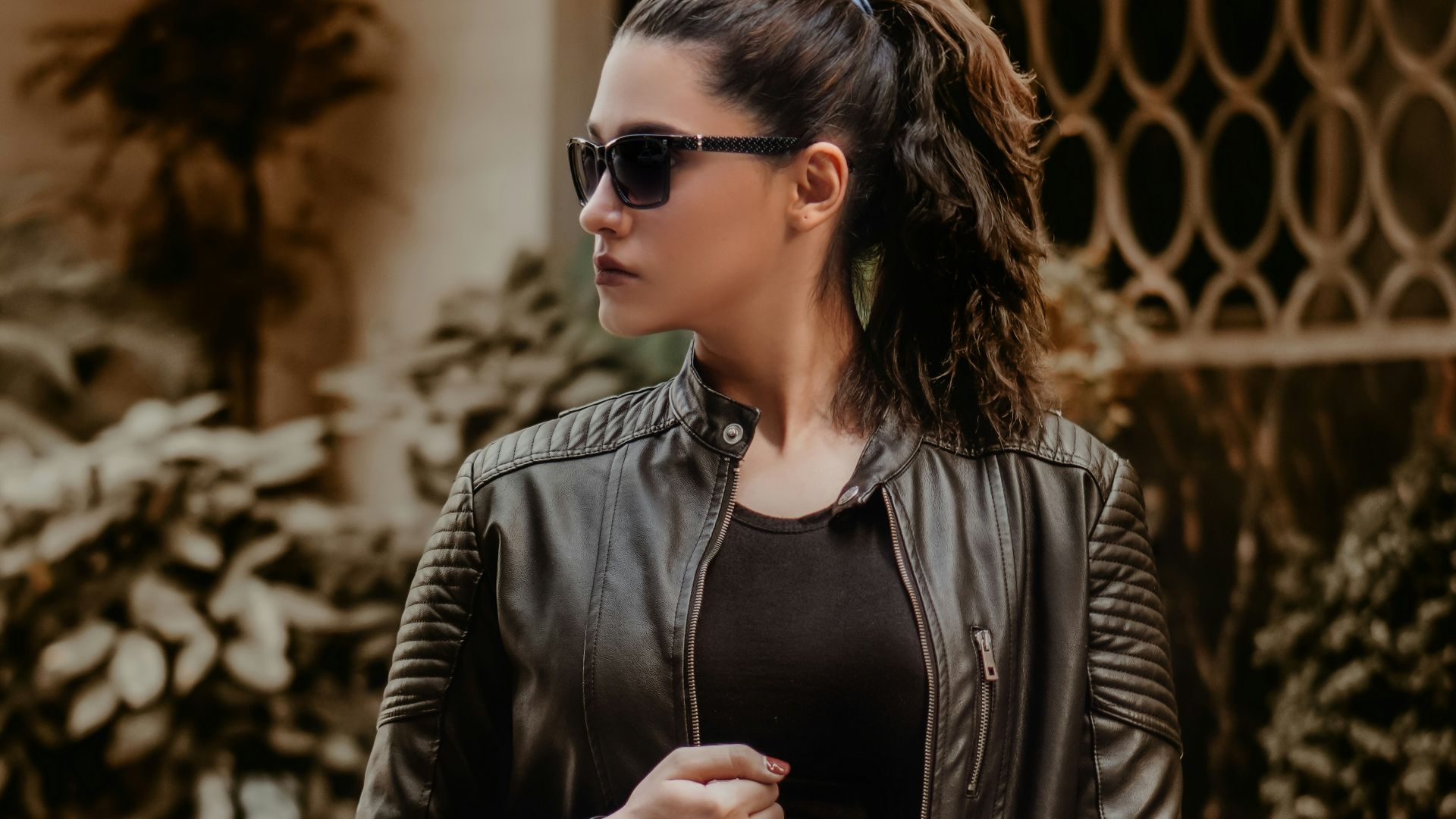 woman in black leather jacket wearing black sunglasses