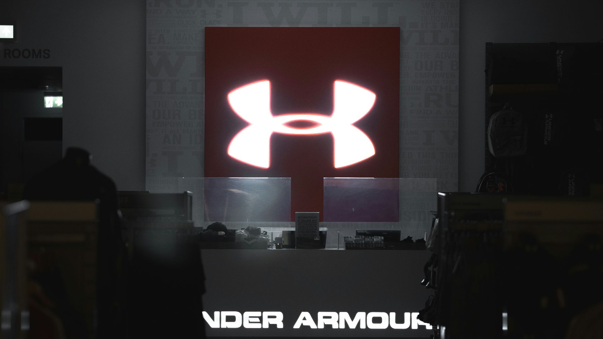 a computer store with a large logo on the wall