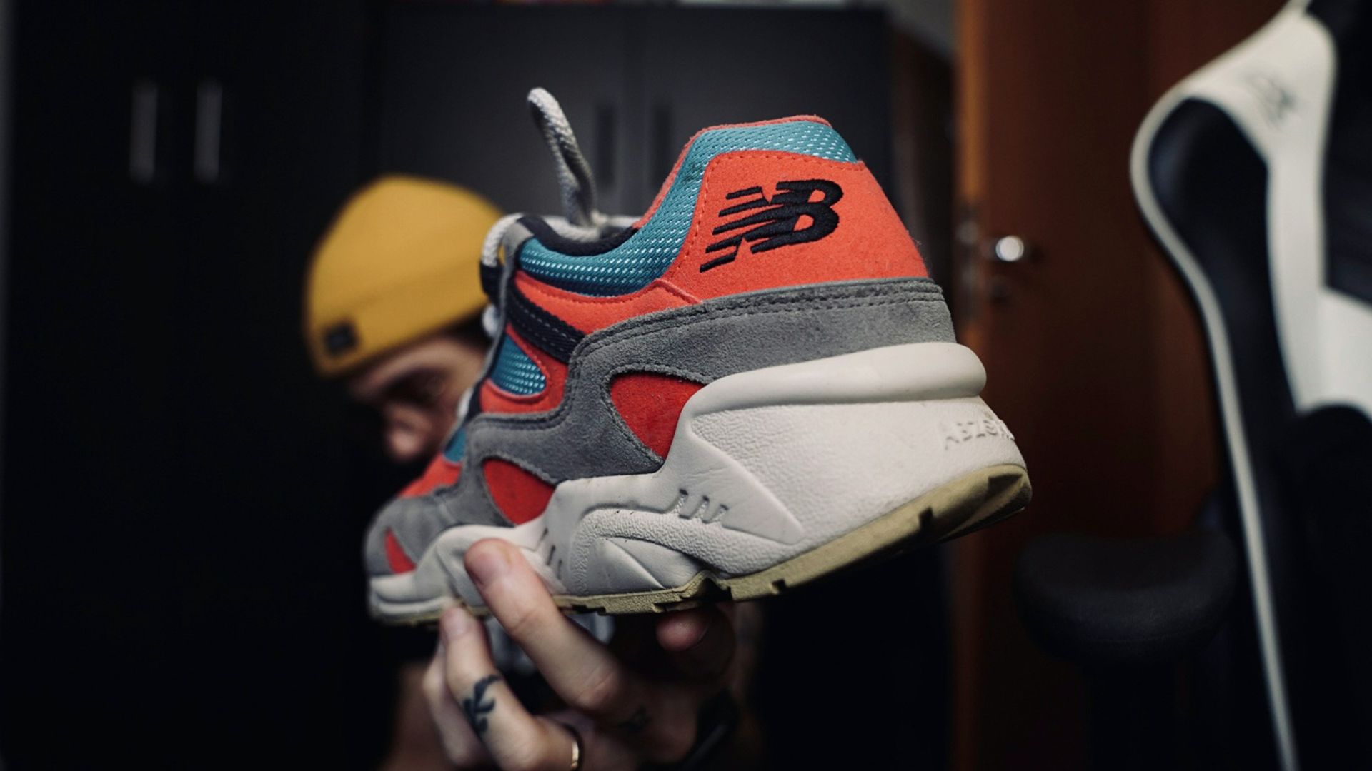 person holding white red and blue nike air max