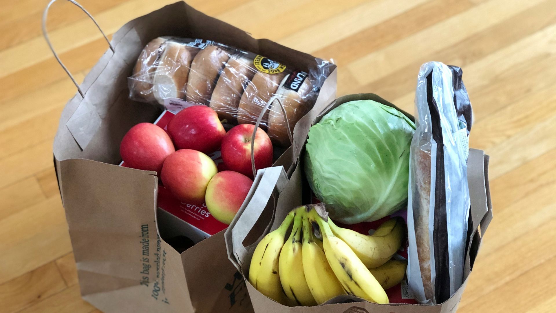 apples and bananas in brown cardboard box