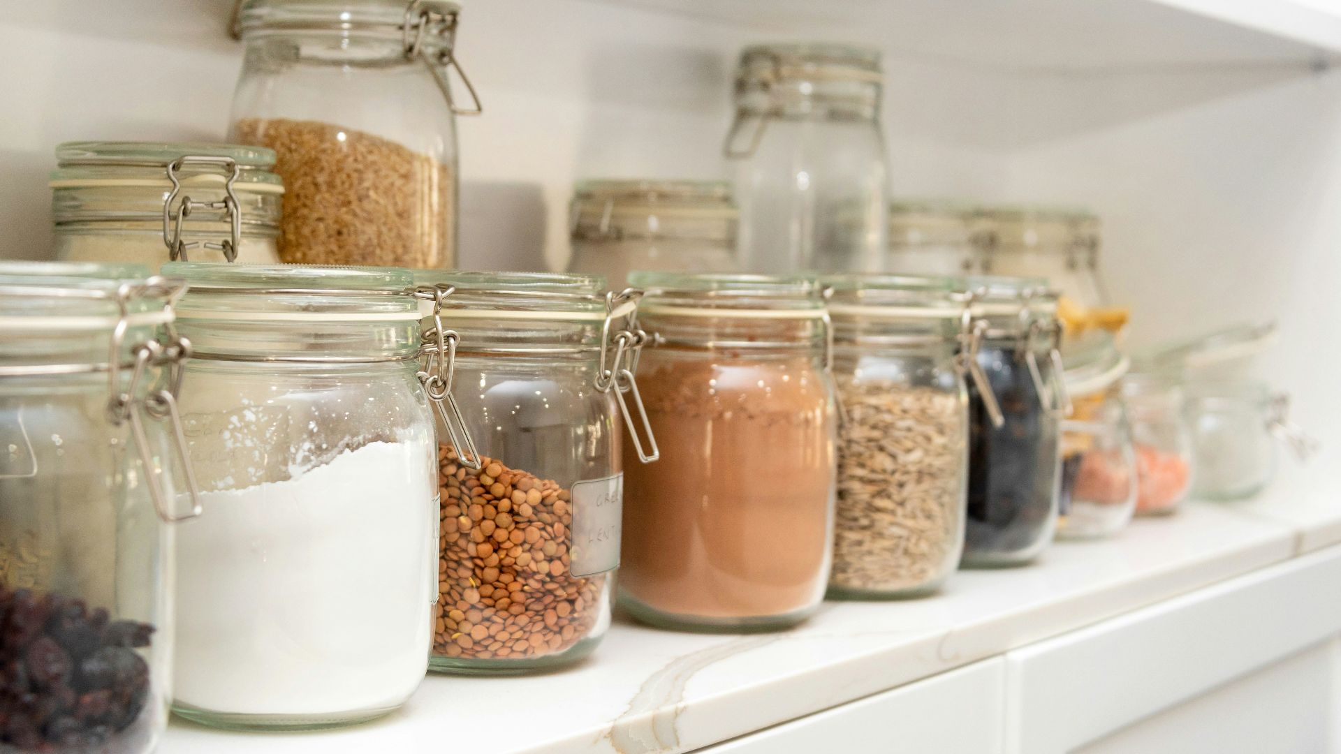a row of jars filled with different types of food
