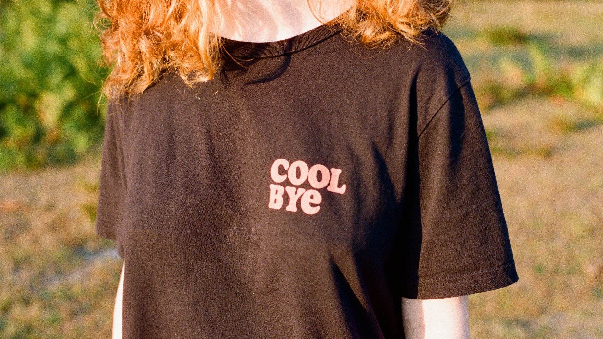 a woman with red hair wearing a black shirt