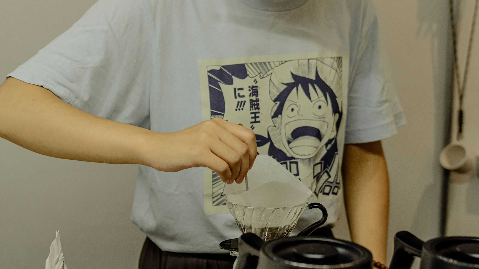 A person is preparing something near coffee.