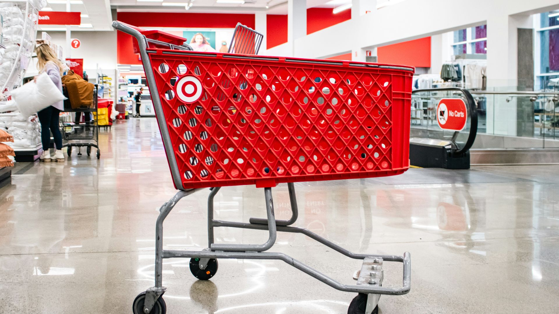 A red target shopping cart sits in an aisle.