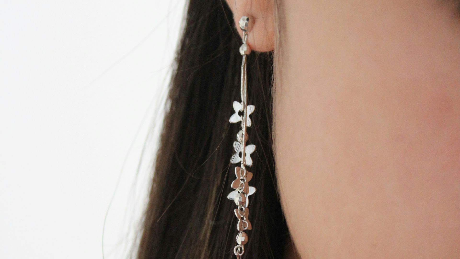 a woman's ear with a necklace