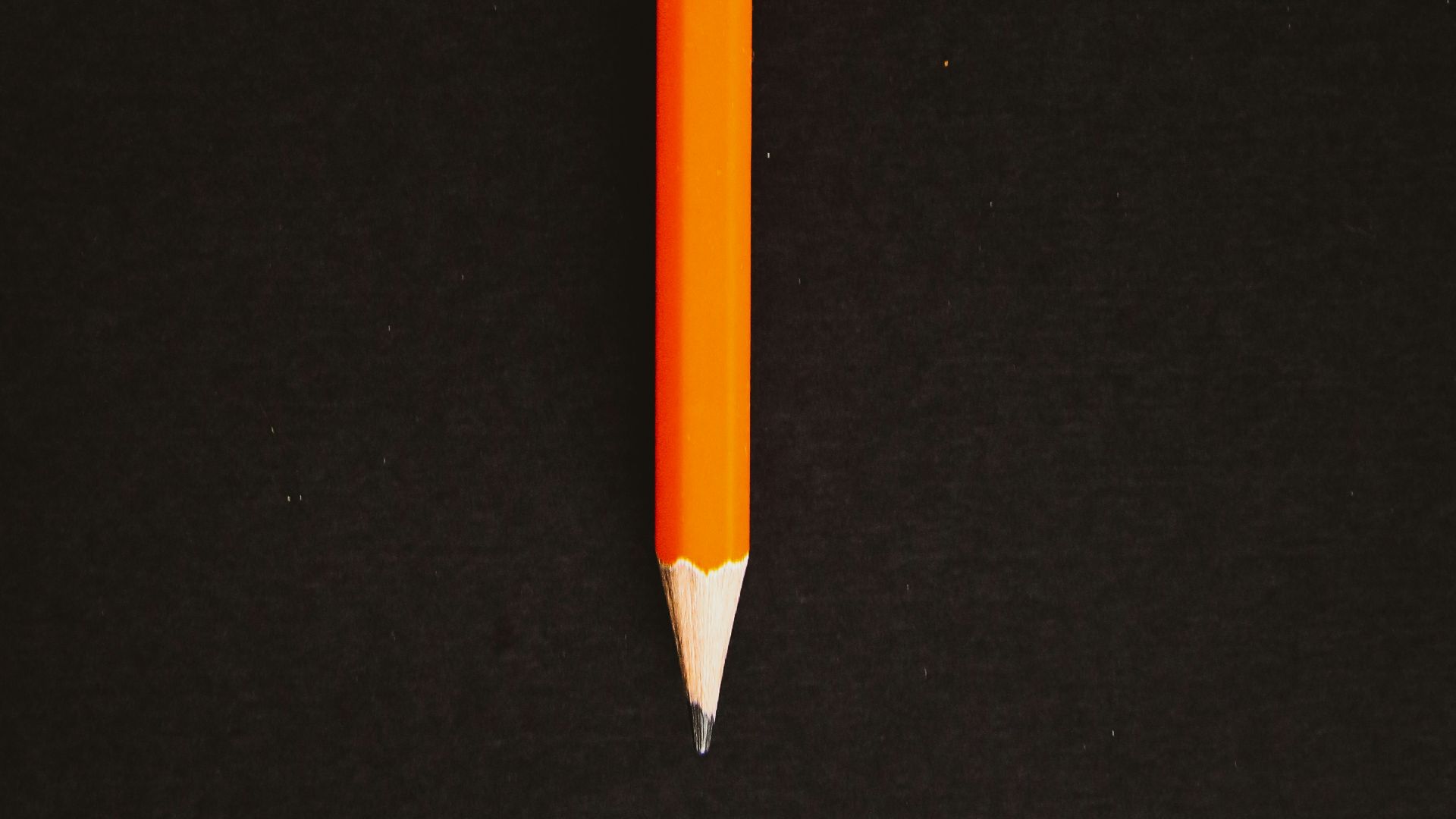 orange pencil on black textile