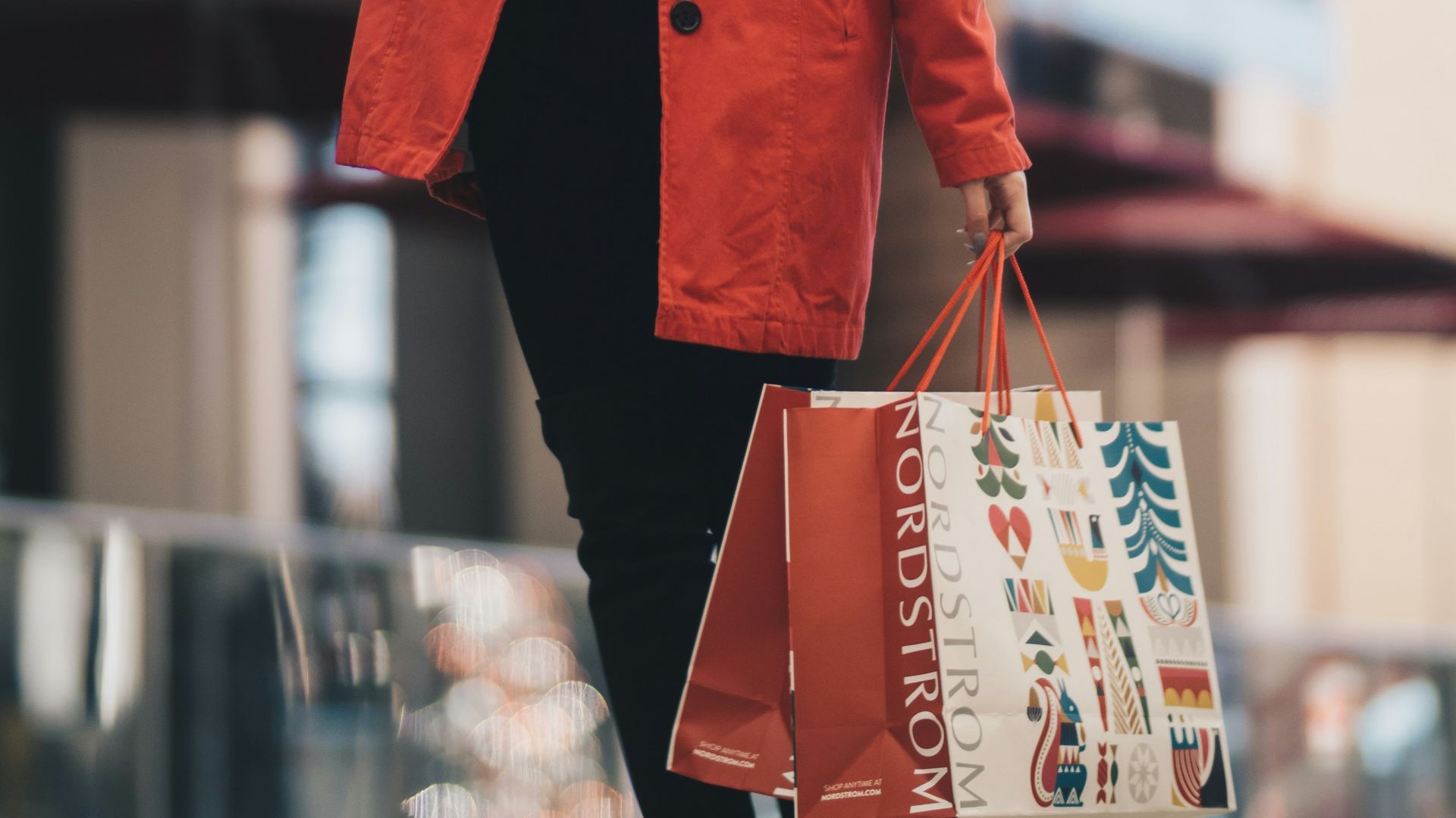 woman holding a paper bag walking on street
