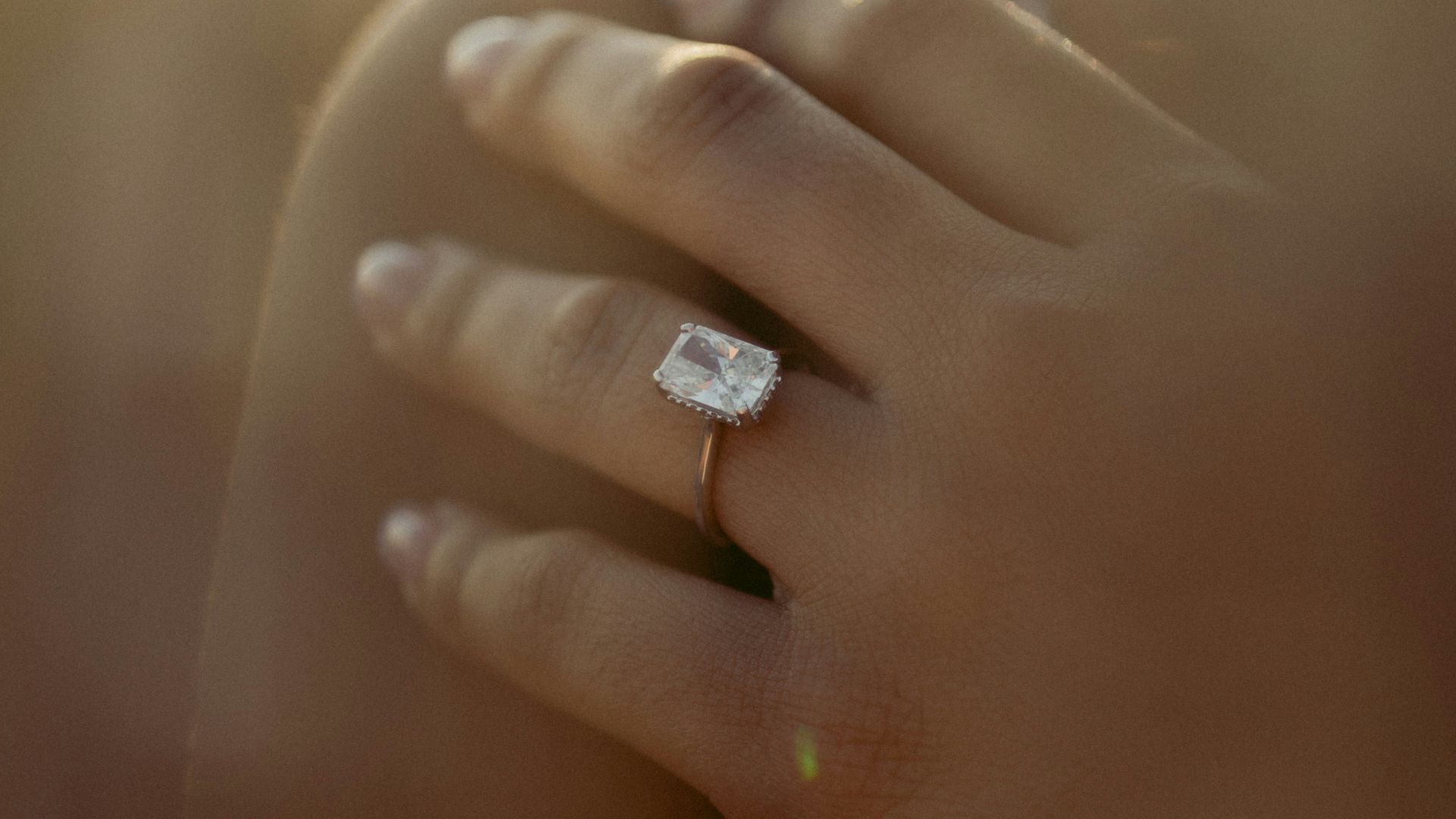 person wearing silver diamond ring