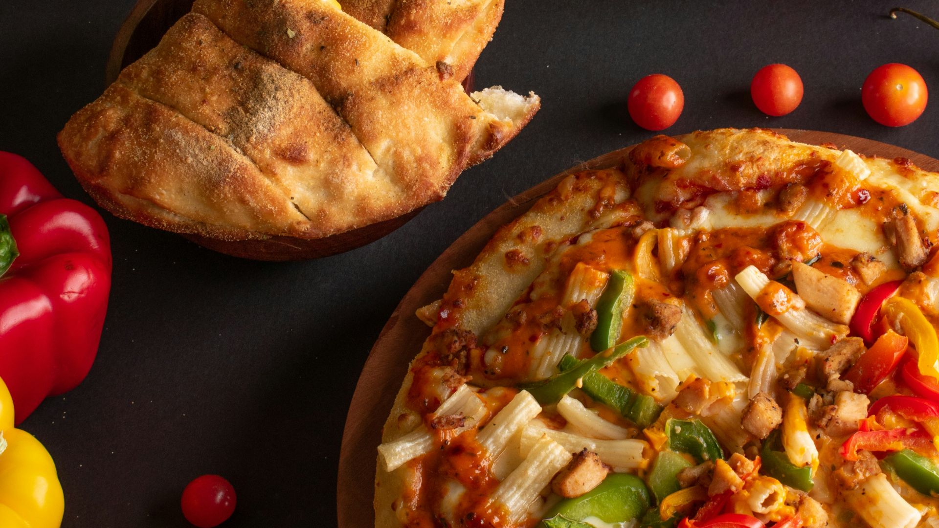 pizza with cheese and tomatoes on brown wooden round plate